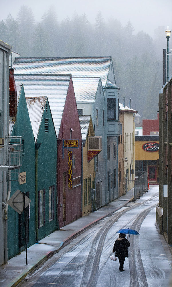  A woman walks along Stage Coach Alley behind the shops on Main Street in Placerville, CA on Friday, February 25, 2011. 