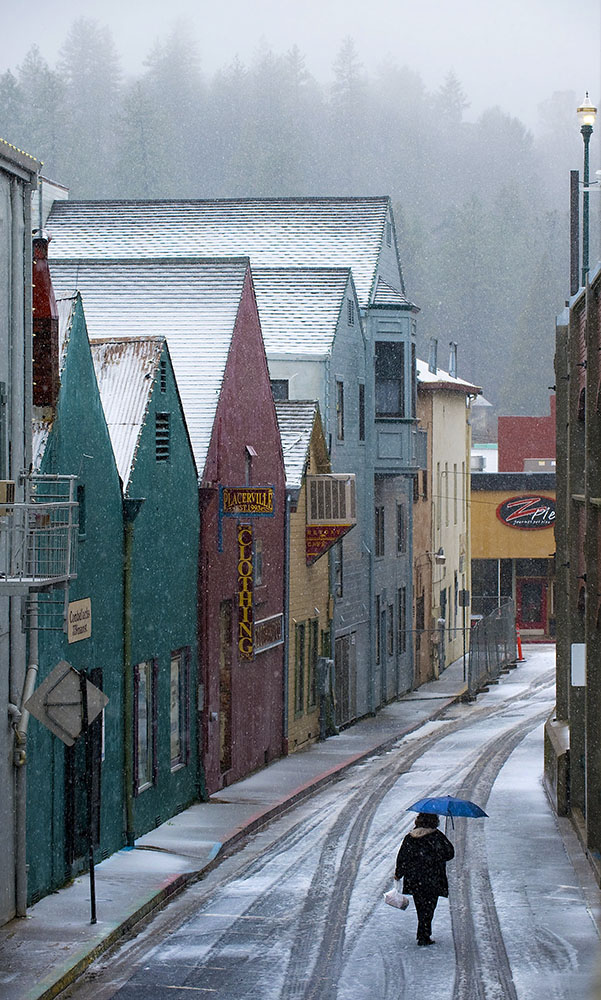 A woman walks along Stage Coach Alley behind the shops on Main Street in Placerville, CA on Friday, February 25, 2011.