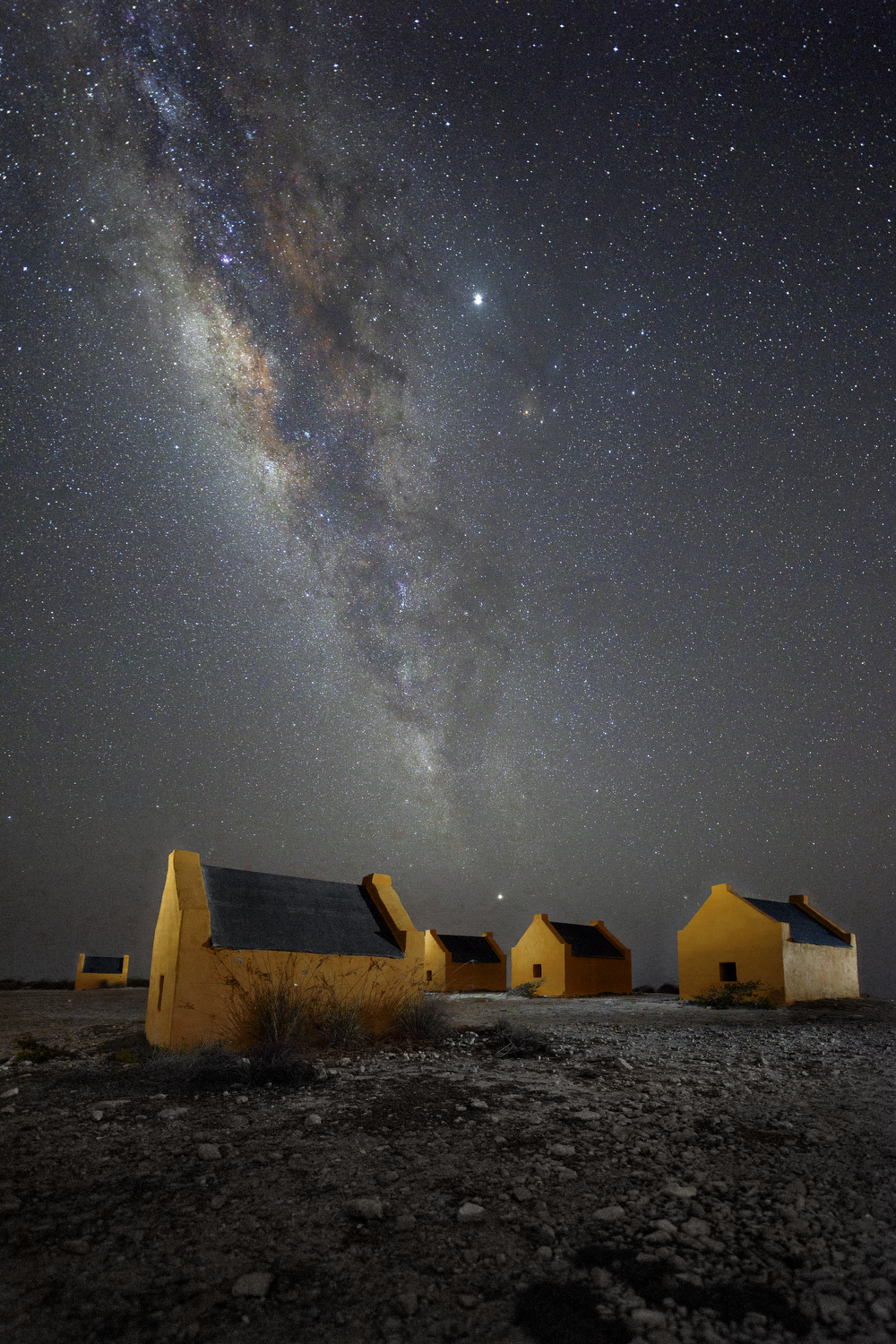  The Milky Way arches above the red slave huts on the southern tip of Bonaire, Friday, July 26, 2019. The four-foot high huts were built in the 1850s, and are a remnant of a time when Dutch colonists used slave labor to extract salt from sea water on