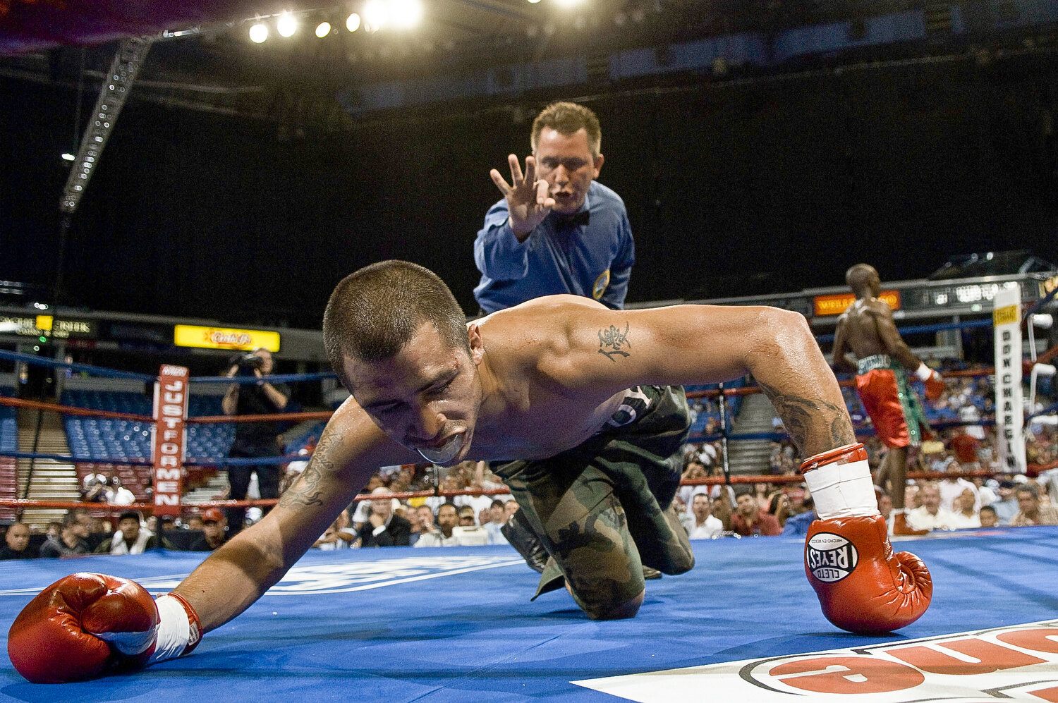  Featherweight title contender Roger Gonzalez of Chino (27-1, 18 knockouts) struggles to get up after being knocked down by Cornelius Lock of Detroit (17-3, 10 KOs) in the tenth round at Arco Arena in Sacramento, Calif., Wednesday June 18, 2008.  Sec