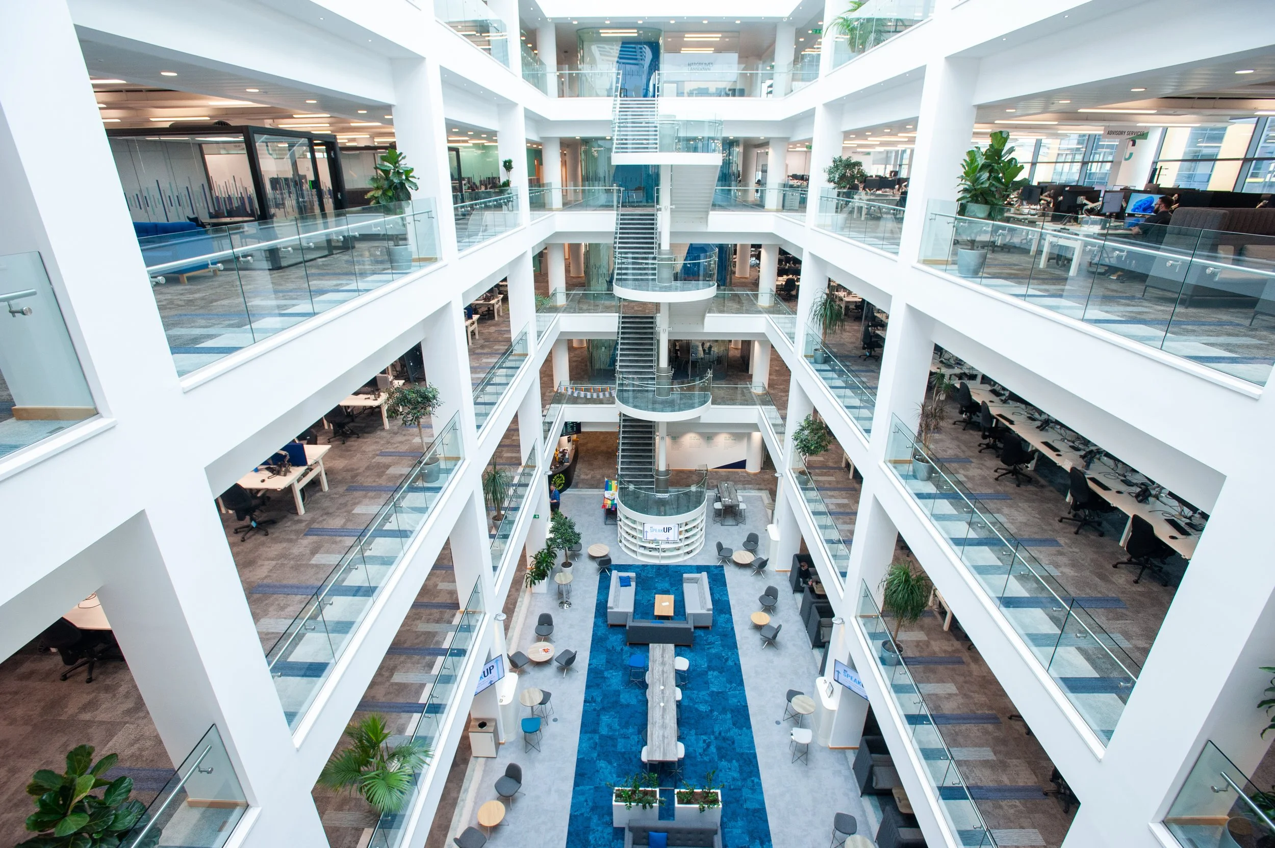 Commercial property and corporate real estate photography featuring a panoramic view of a contemporary financial services headquarters with an open-air internal courtyard.