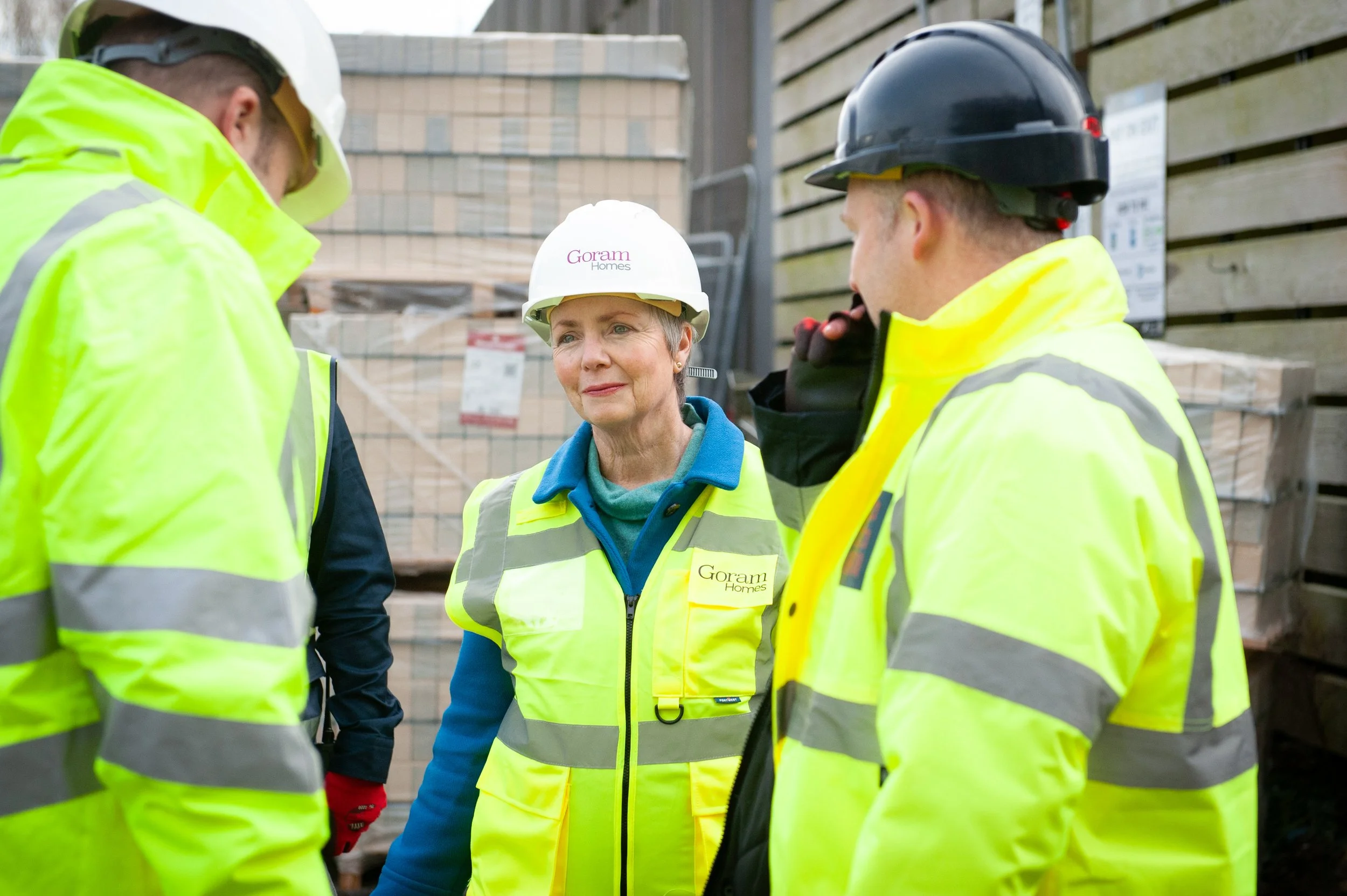 Bristol South MP Karin Smyth touring a Goram Homes construction site wearing high-vis safety gear.