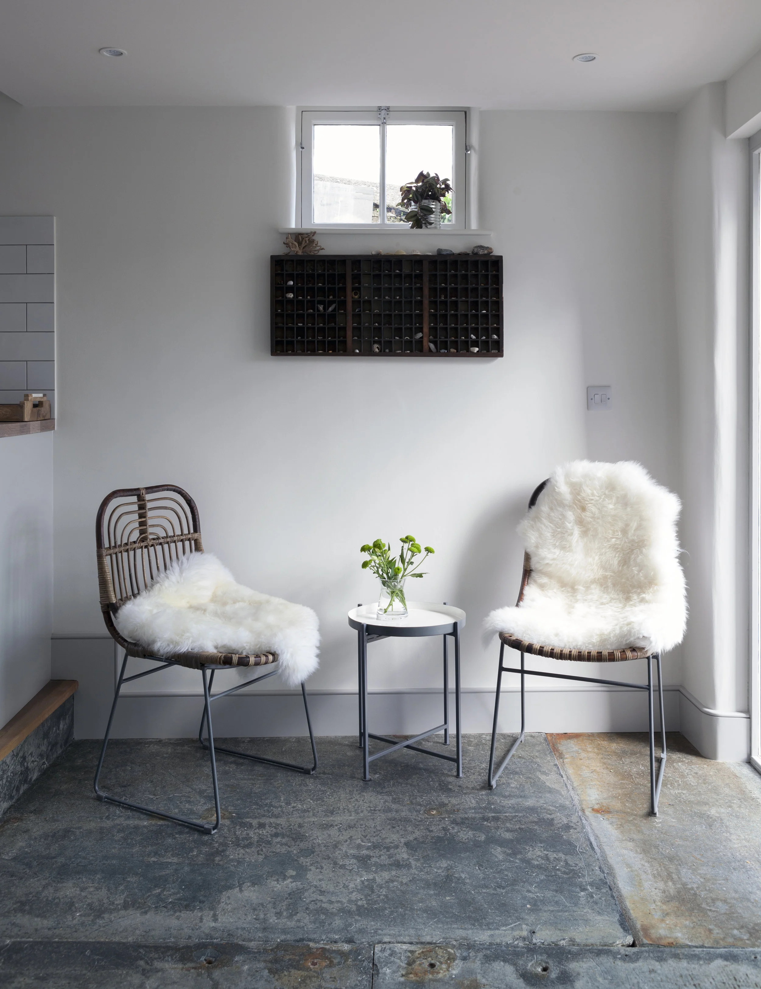 Location: Port Isaac, Cornwall Project: Snug coffee corner. Sheepskin rugs, textured chairs, original slate floors surround the lovely old printers drawer and collection of locally found shells.
