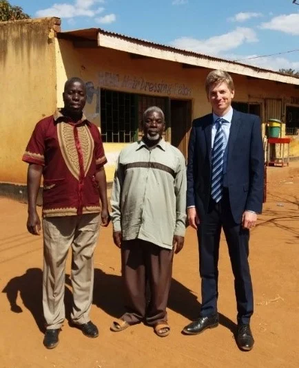 Huw in Katantha Village, Tsabango, Malawi, with village chieftains interested in adopting our service for their communities.