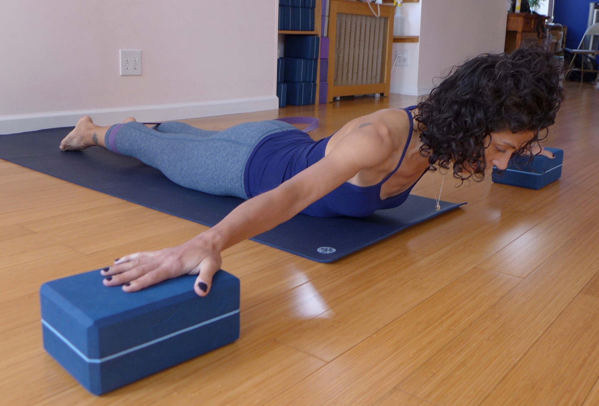 Cobra pose variation, Part 2: Follow the same key actions as above, just move the blocks off to the sides of your mat and place your arms into a "t" shape. Try to drag the blocks towards you without actually moving them. This version helps with thoracic mobility. 