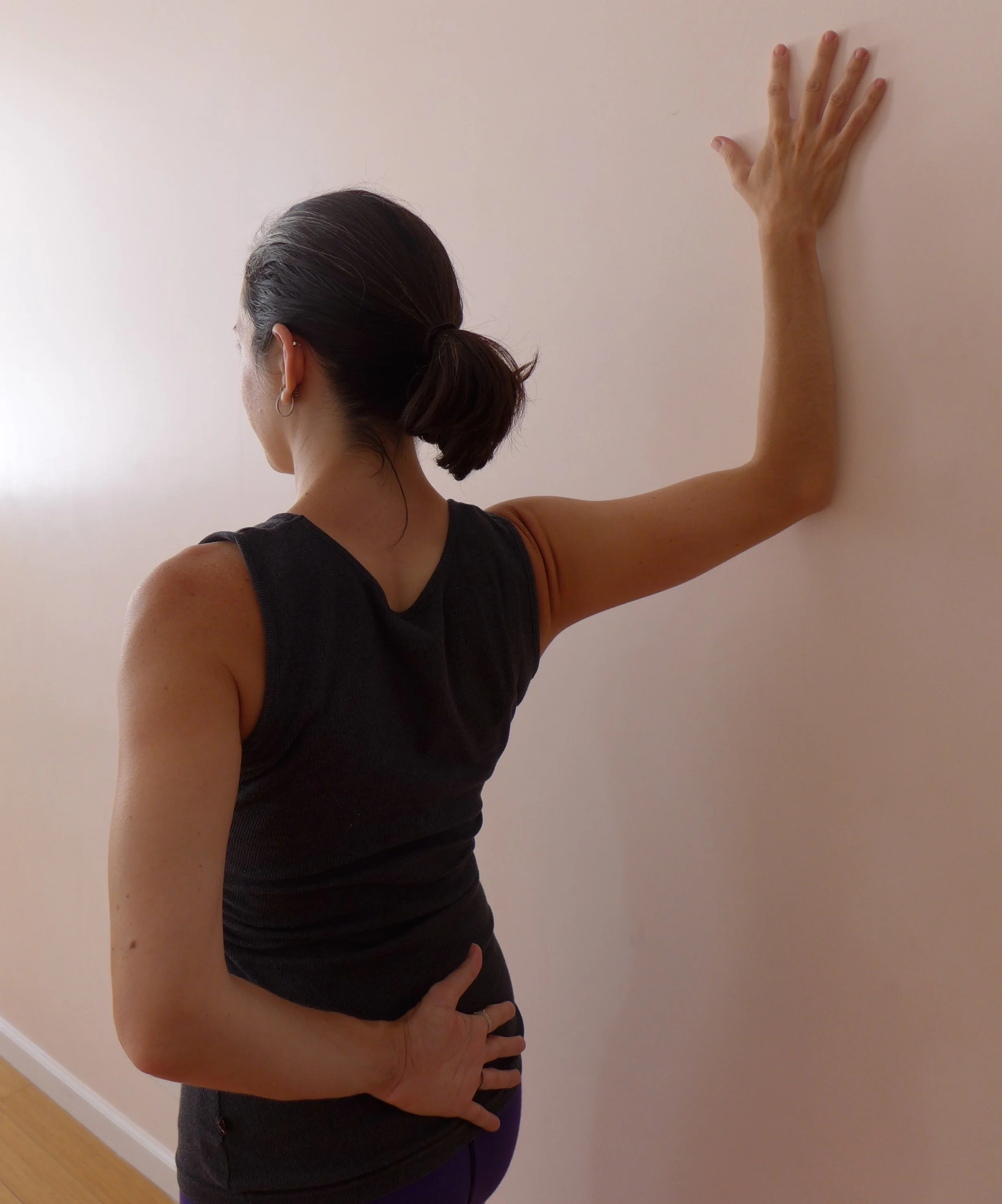 Pec Stretch at Wall: An oldie but a goodie! Place your forearm at the wall behind you, work to keep the elbow at the height or higher than the shoulder. As you turn your body slightly away from the wall, press your forearm into the wall to keep the head of the humerus (upper arm bone) integrated with the shoulder joint so you get the stretch in the pecs and biceps line and not in the joint itself.