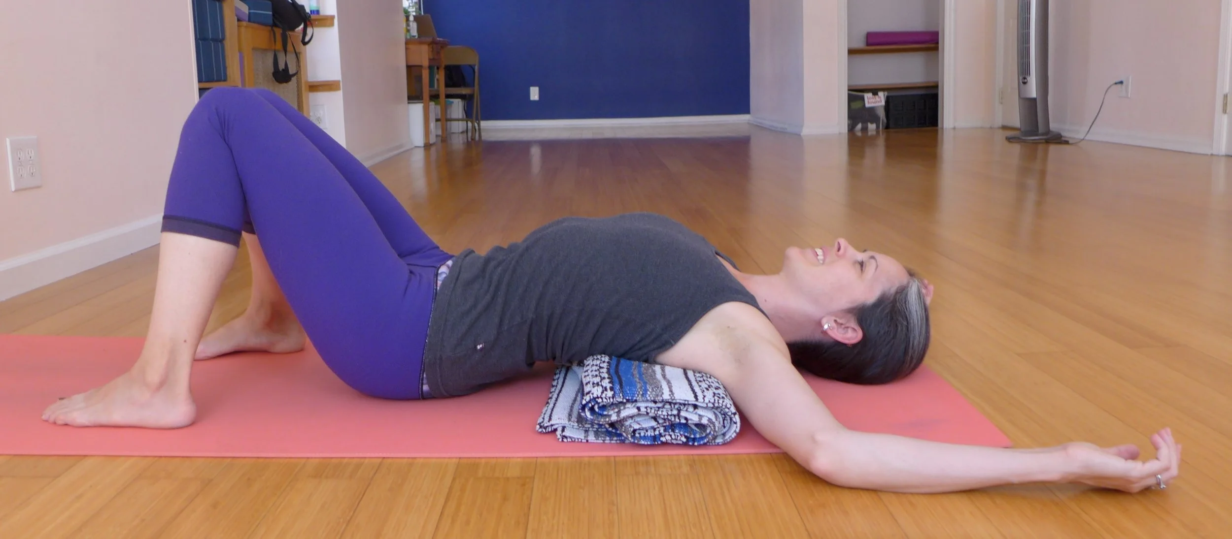 Supported Fish: Do this EVERYDAY! You can roll up a blanket and place the lower half of your scapulae on the top of the blanket roll. Have your knees bent (less stretch on the abdomen) and slide yourself up in the direction of your head so you can rest your arms on above the blanket roll. Keep this roll very small if you are post op or working with diastasis.