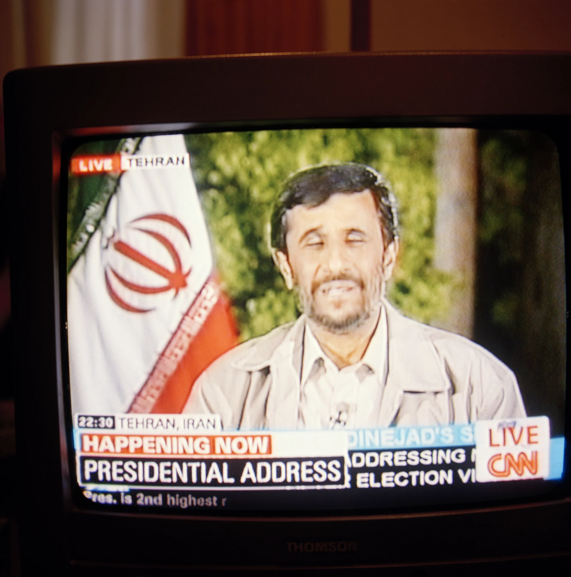 20:00 With CNN still on the TV, glued to the news coming out of Iran, I watched as Mahmoud Ahmadinejad “the Iranian George W. Bush” gave his victory speech. Notice the official time in Iran (22:30) – I had no idea Iran that was 3 hours, 30 minutes ahead of Madrid. I always thought international time zones were separated apart in increments of whole hours. Then I remembered that some countries do that kind of thing. Until I got the film back from the lab I had no idea I had caught with his eyes half shut – how appropriate.