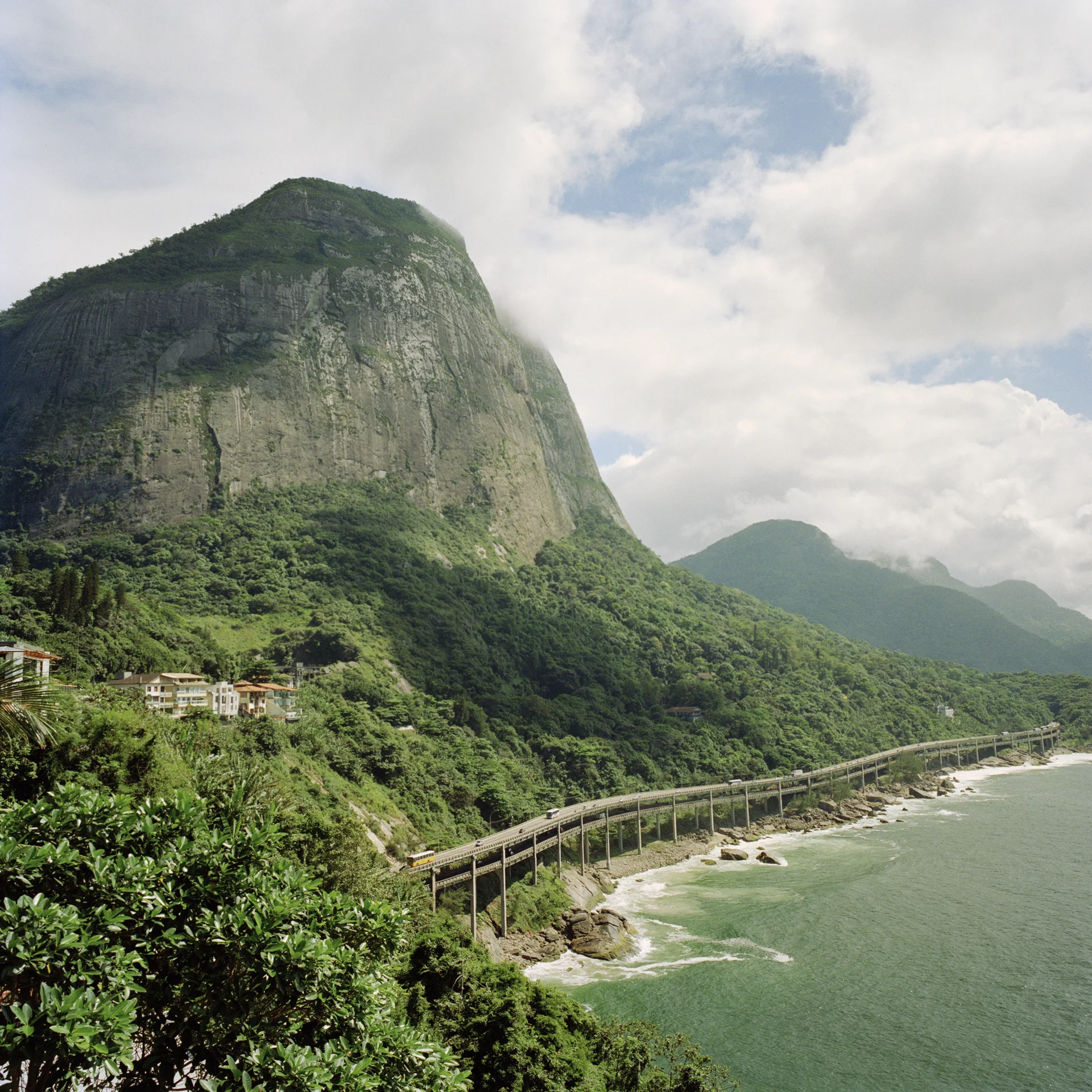 View of the Pedra da Gavea mountain from the Joatinga neighborhood, with the Elevado Das Bandeiras highway below.