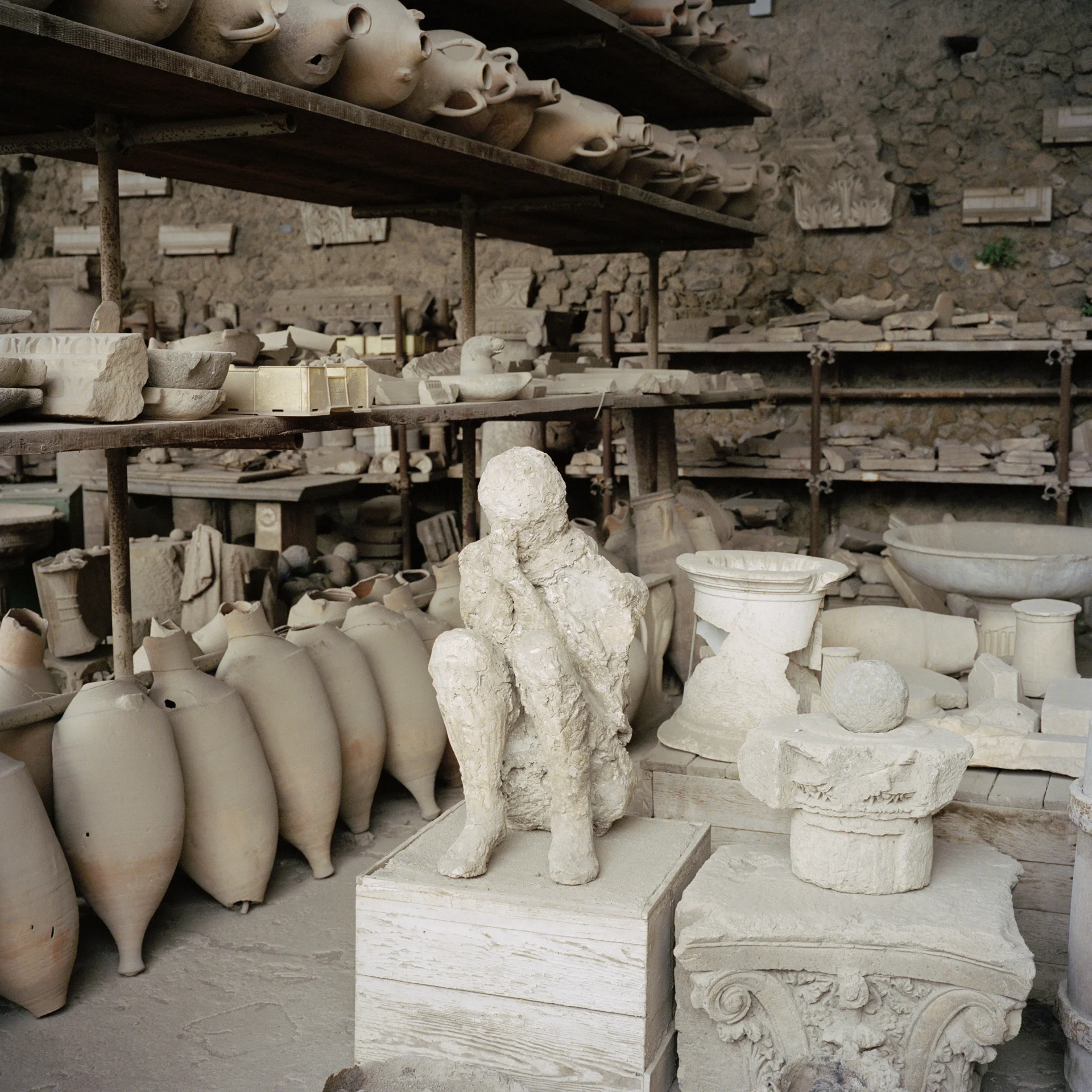 Pompeii. Plaster cast of a victim of the Mount Vesuvius eruption. Along with other artefacts.