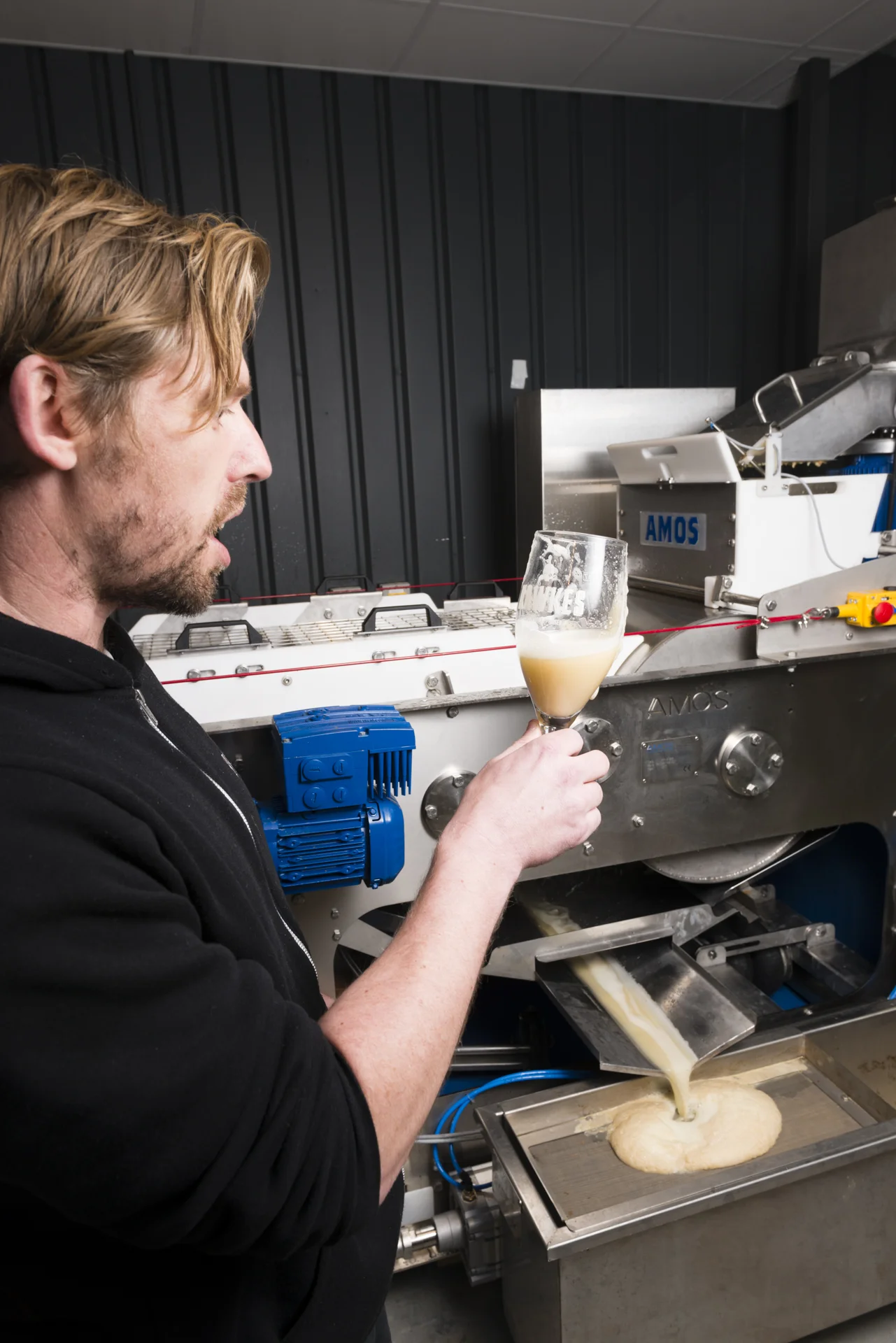 Simon Wright of Hawkes Cider's checking the quality of the raw cider coming from the press.