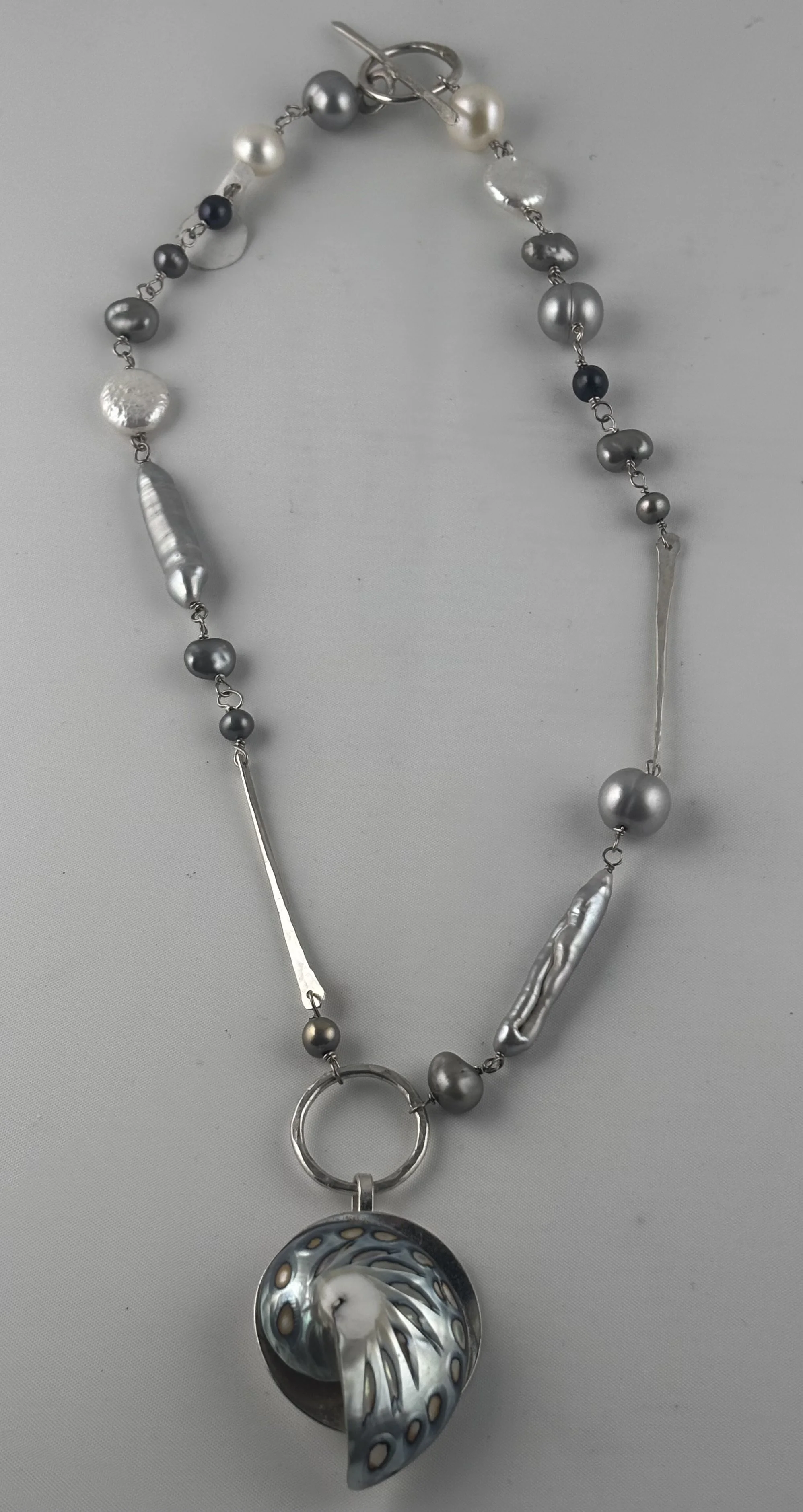 Nautilus shell with chain of pearls
