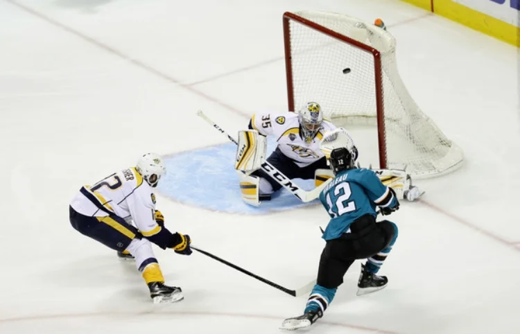 Patty Marleau goes top shelf to light the lamp on Nashville goalie Pekka Rinne. (photo by Ezra Shaw) 