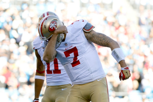  Colin Kaepernick kisses his bicep following a 49er touchdown. (photo by Kevin C. Cox)