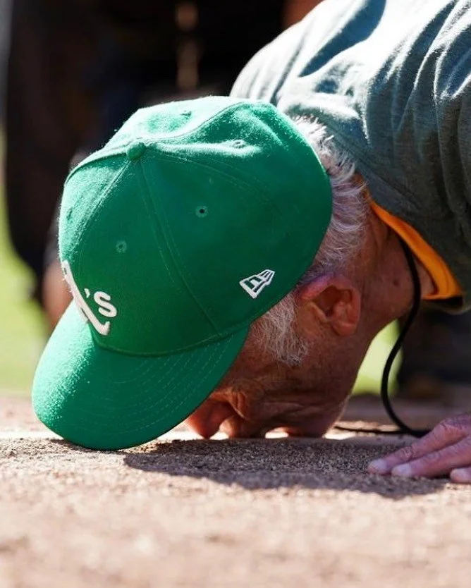 @kavin_mistry captures this image of legendary Oakland A&rsquo;s photographer @michaelzagaris kissing the Oakland Coliseum pitching rubber goodbye.