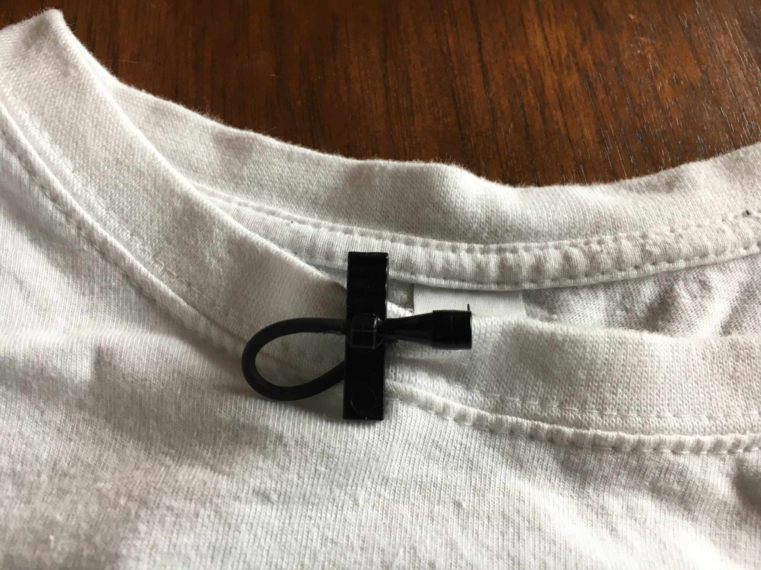 Step 5. Clip the mic onto the collar, or edge of the garment you are miking and sandwich the cable under the clip so it keeps the loop small. Lavalier mics are usually omnidirectional so if it faces sideways, don't worry, you'll still hear them fine. 