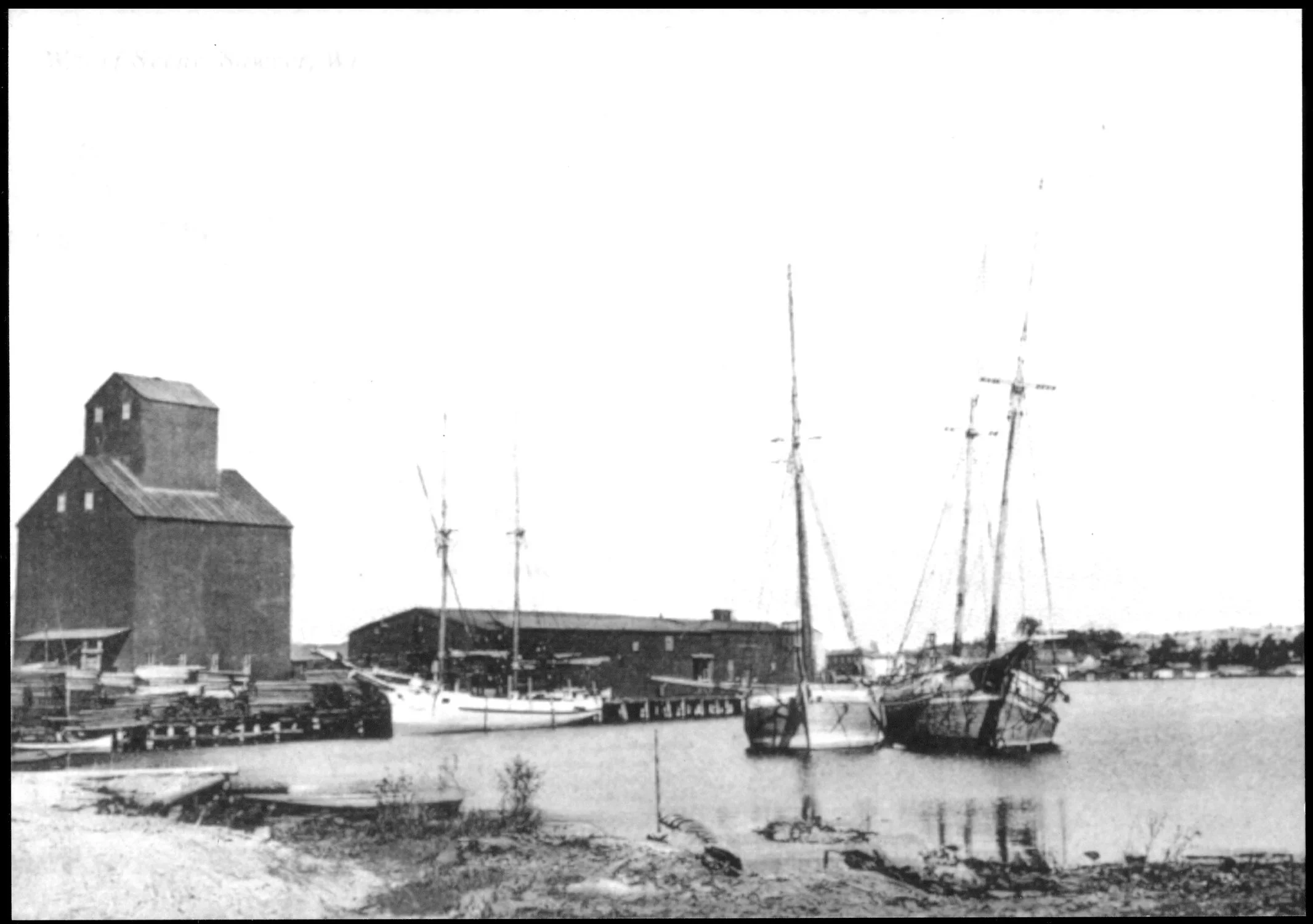 Teweles and Brandeis Grain Elevator and warehouses on the large dock along the working waterfront (Door County Historical Museum)