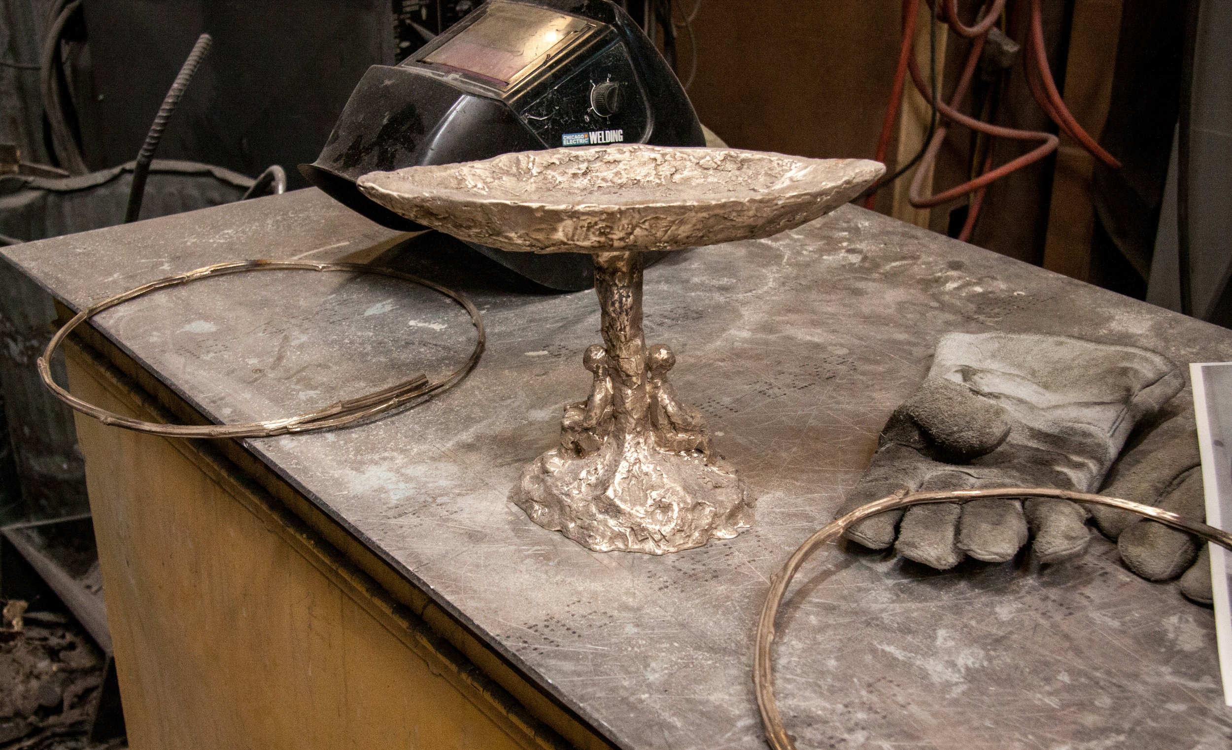 The two circular tree branches will be welded to the sculpture to form the two circles surrounding the chalice flame.