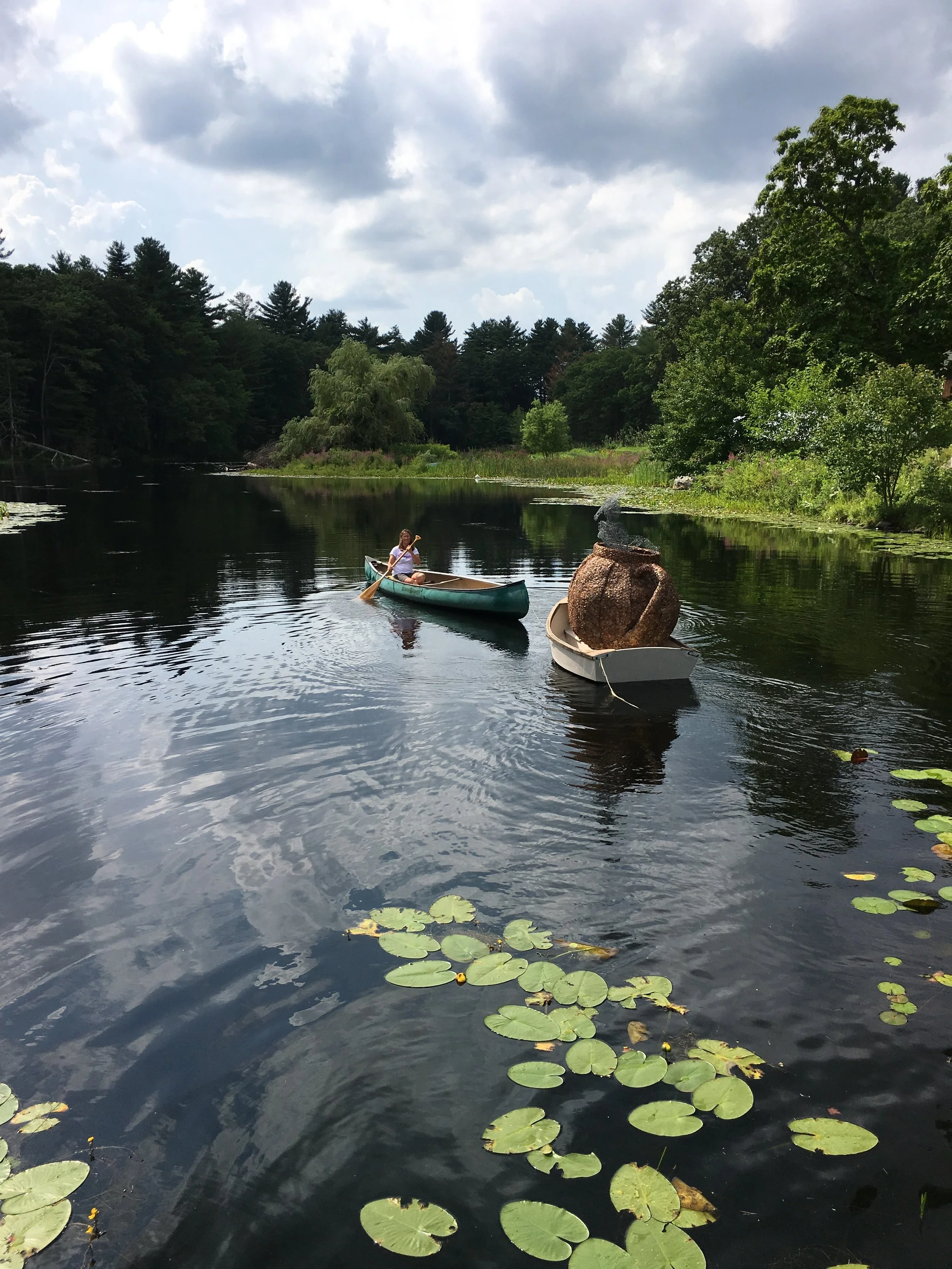 Gabi in the canoe taking our sculpture for a tour of the pond.