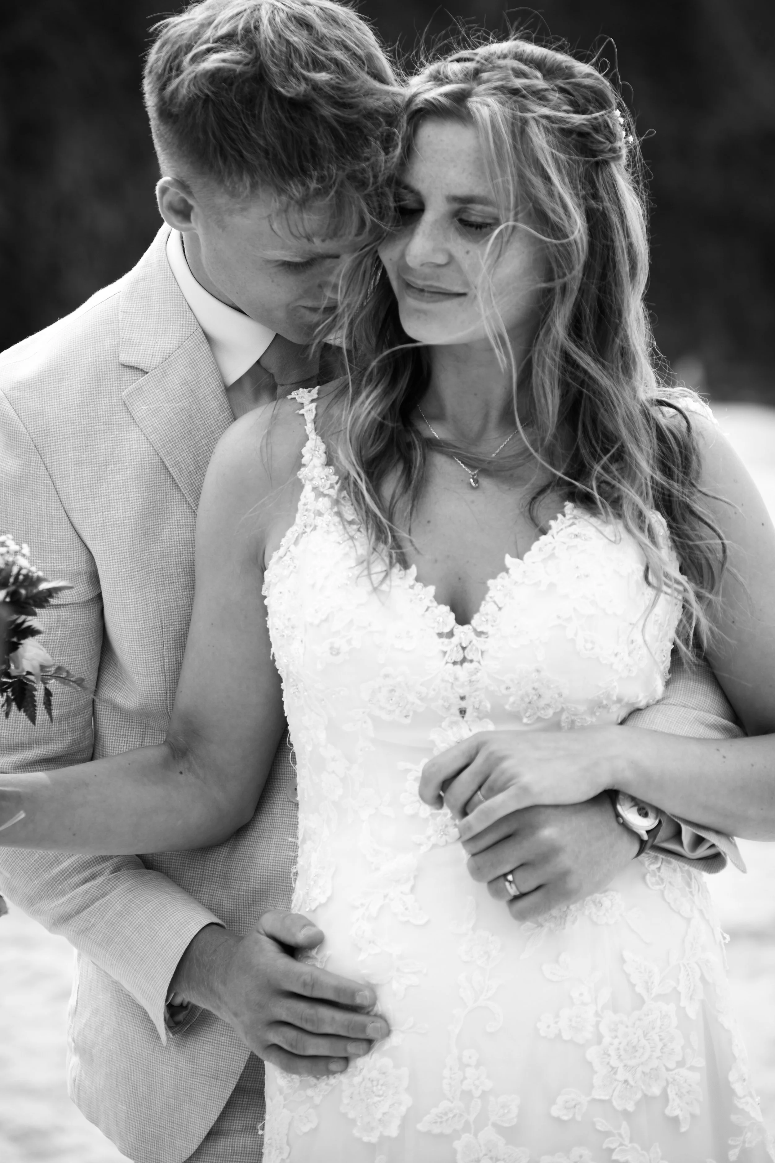 A couple embrace on a cornish beach