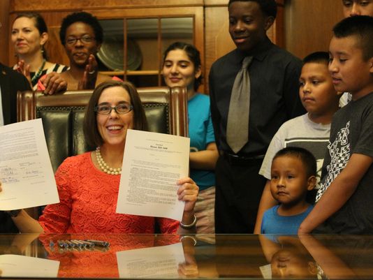 Governor Kate Brown signing into law HB3499 with students and members from communities of color. (Photo: Gordon Friedman / STATESMAN JOURNAL)