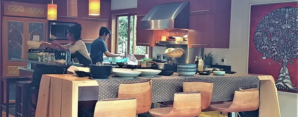 Two Barn Nork chefs cooking a chef dinner in a private home kitchen, plates and bowls stacked ready to serve