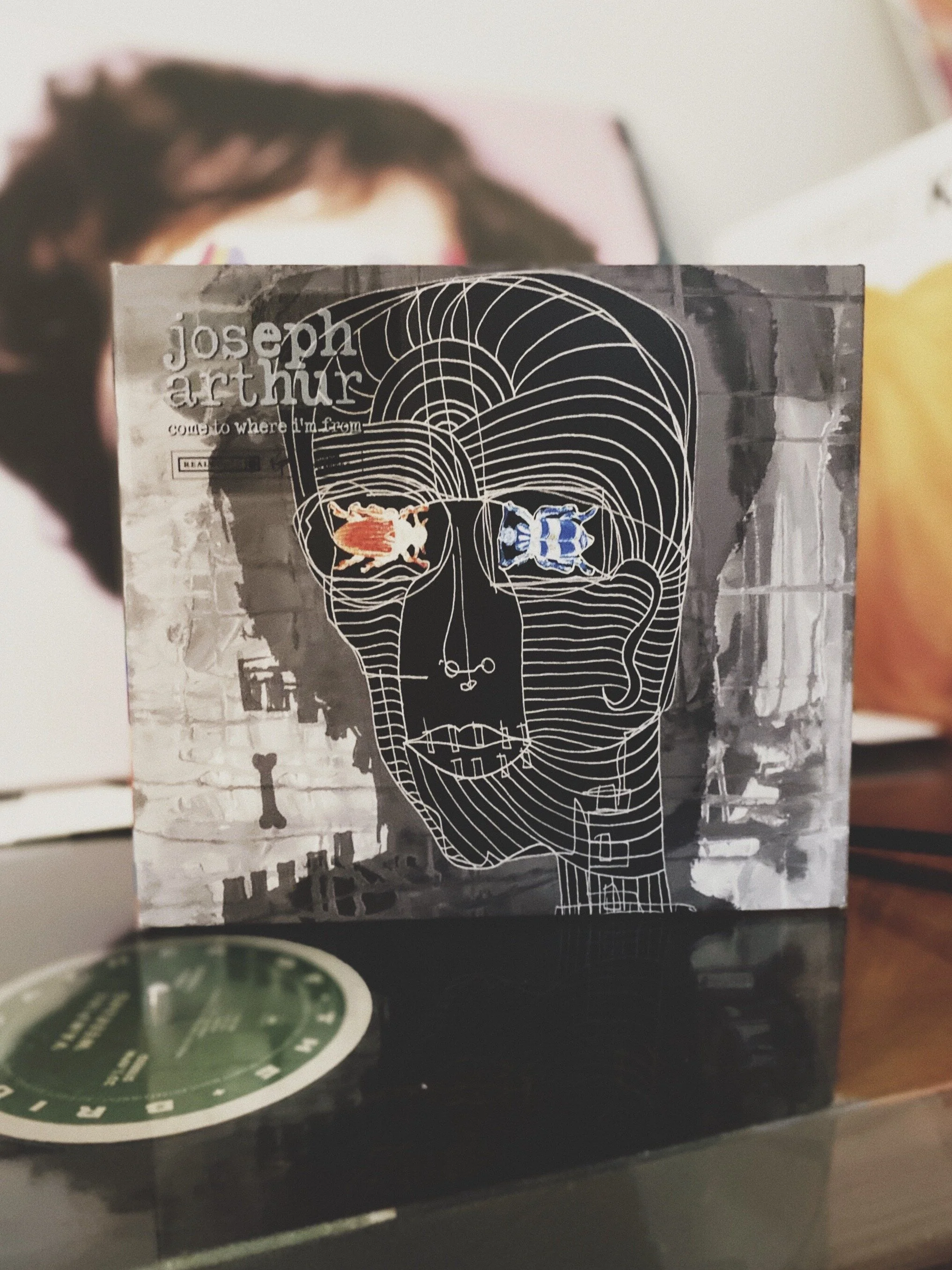 5. Joseph Arthur: Come to where I come from   I was 20. So much had changed since I had joined  Blue Room . I was in a real studio and we were making a real record. This creative work of some people sitting in a room, trying to find the essence of a song and put it on tape (yes, it was on tape) still drives me today.  It was  MTV  again that made me discover  Joseph Arthur.  I had to order the CD and wait for weeks to get it as this kind of alternative stuff wasn’t really easy to find in Luxembourg. But back then and still today, you could count on the  Plakkebuttik beim Palais  to come by with your poison, no matter how extravagant it was.  This record is strange and beautiful. Maybe a little overproduced here and there but in a wonderful and creative way.  It’s sad. And angry. And full of hope.