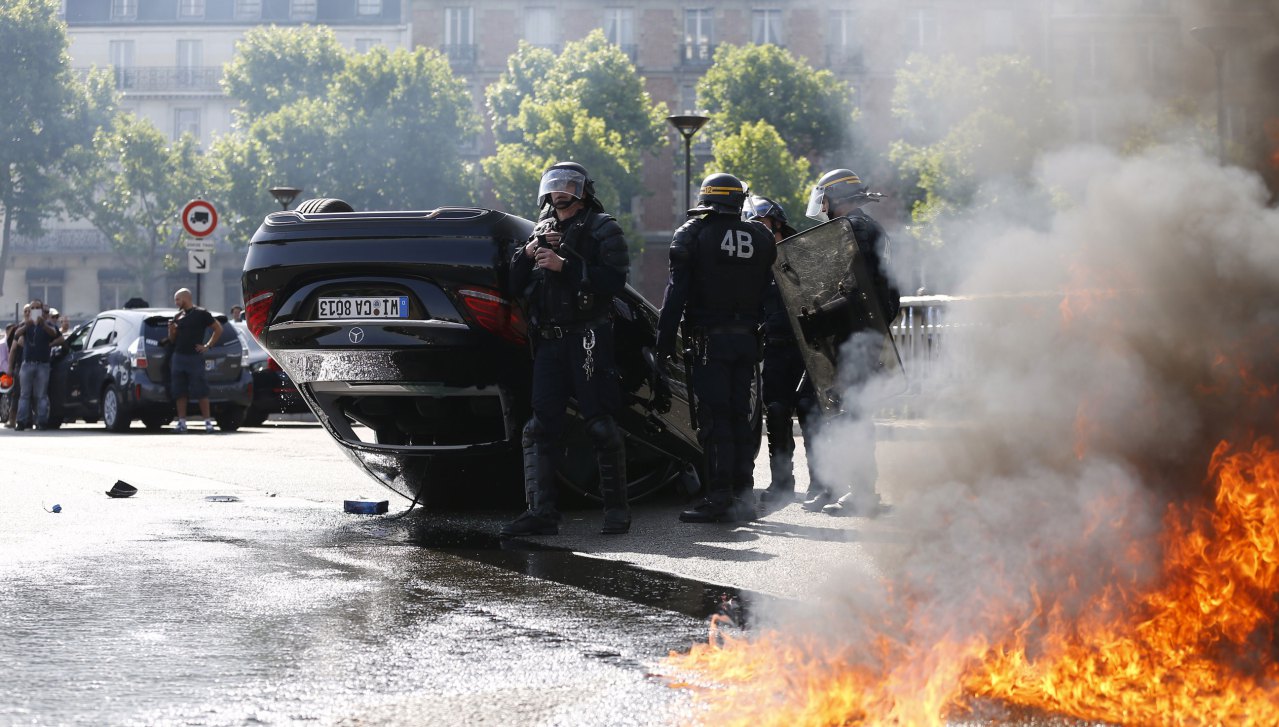 http://techcrunch.com/2015/06/25/french-anti-uber-protest-turns-to-guerrilla-warfare-as-cabbies-burn-cars-attack-uber-drivers/#.dlih31:nrMh