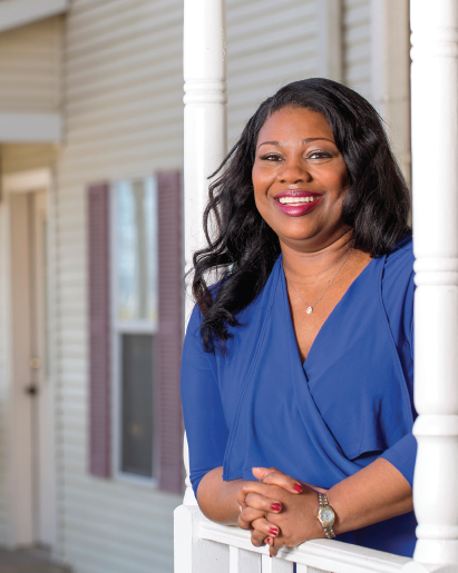 Kimberly Lacy stands on the front porch of the Ronald McDonald House in Little Rock. Photo by Beth Hall.