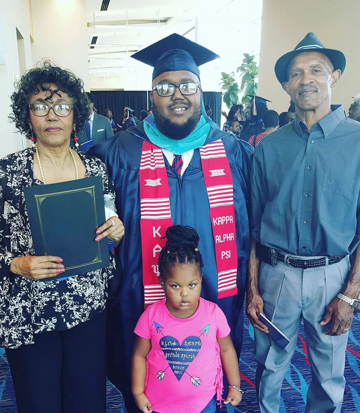 Daisy lee, lorenzo lewis, sareya and t. royal lee celebrate as lorenzo receives his Master's degree.