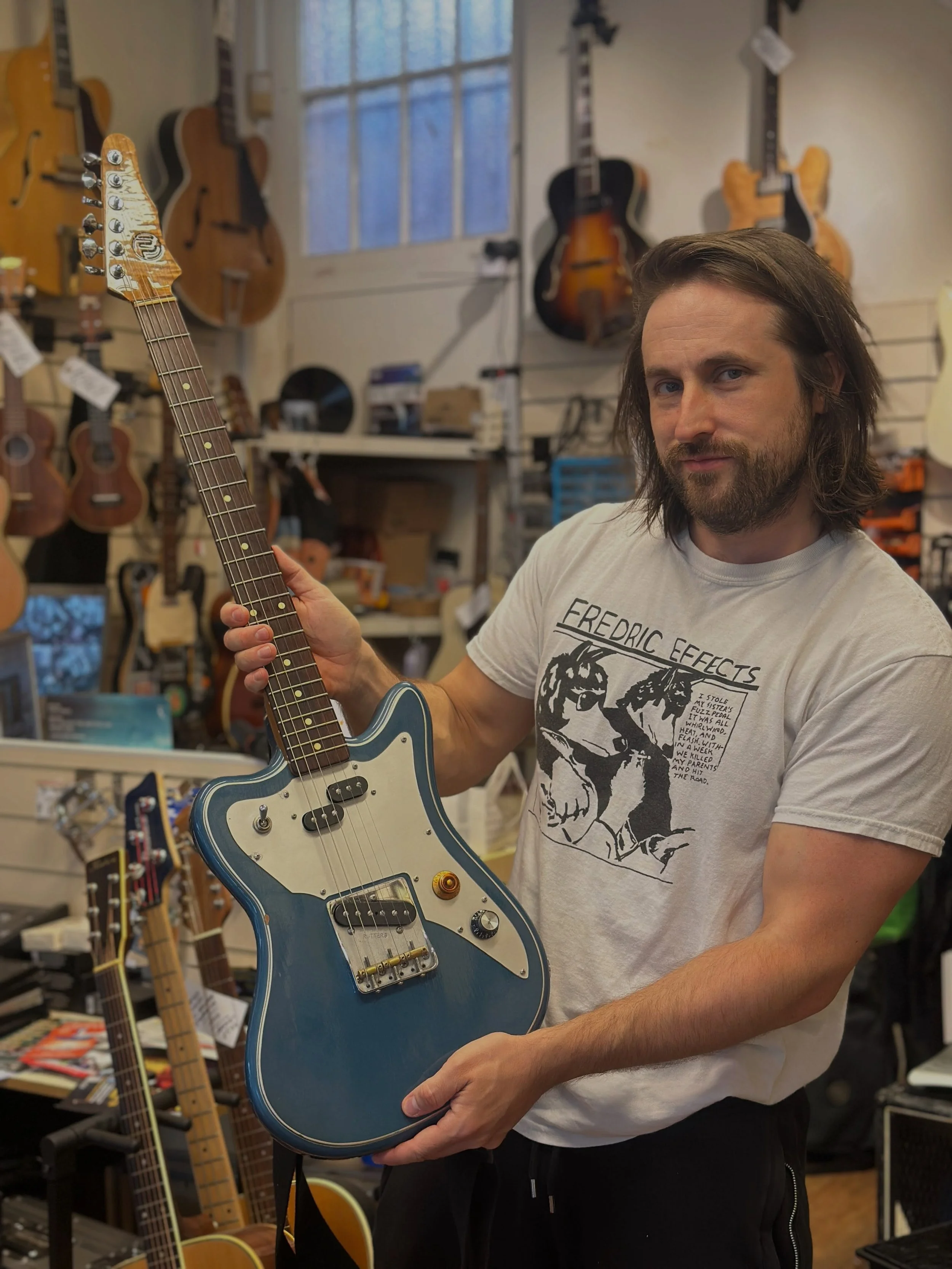A sexy man with a sexy guitar! 

Alex from @wehavesoundguitars gripping his @walshguitars with fervent glee!

#guitarshop