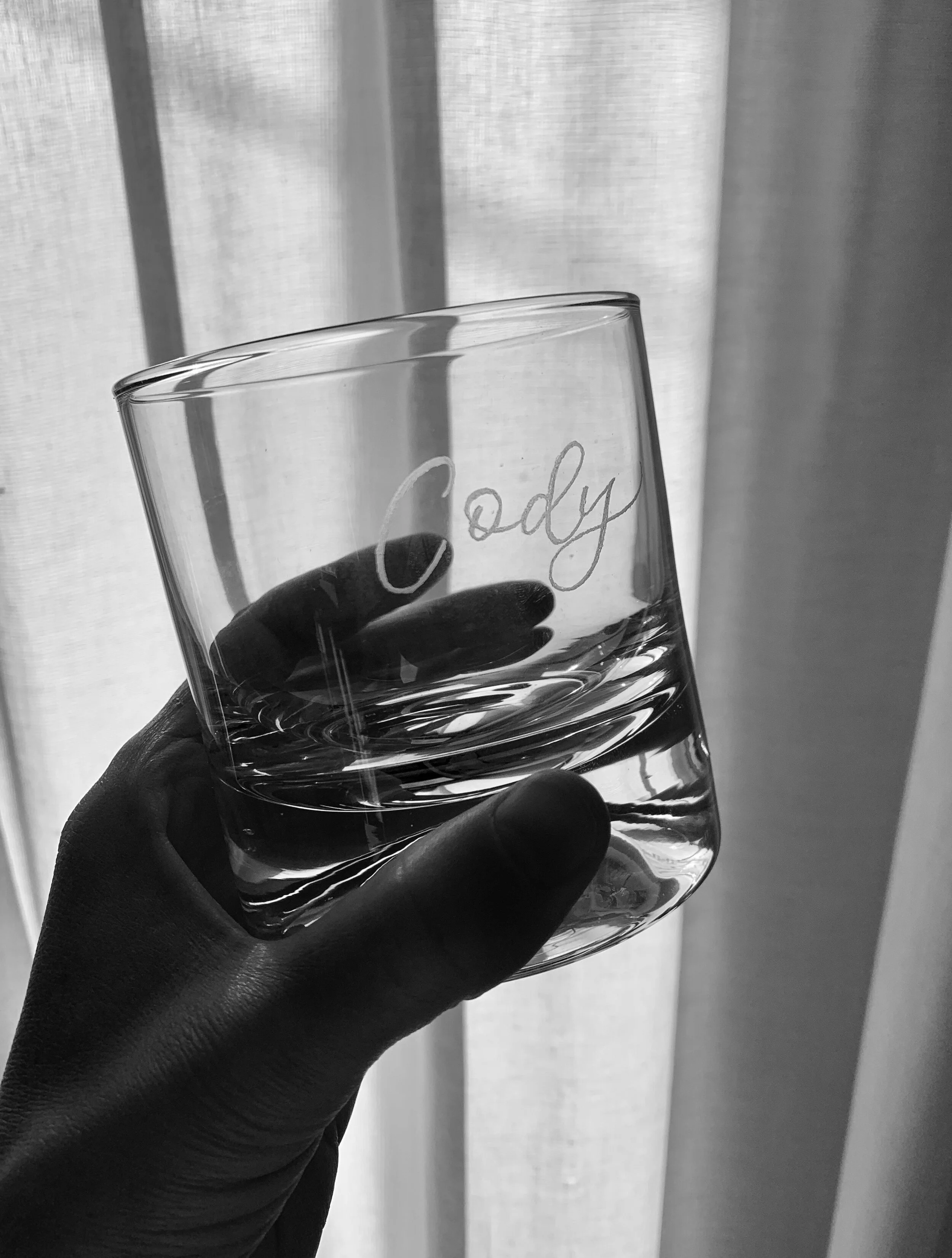 Emily A Howell live event calligrapher engraving custom calligraphy on whiskey glass for guest