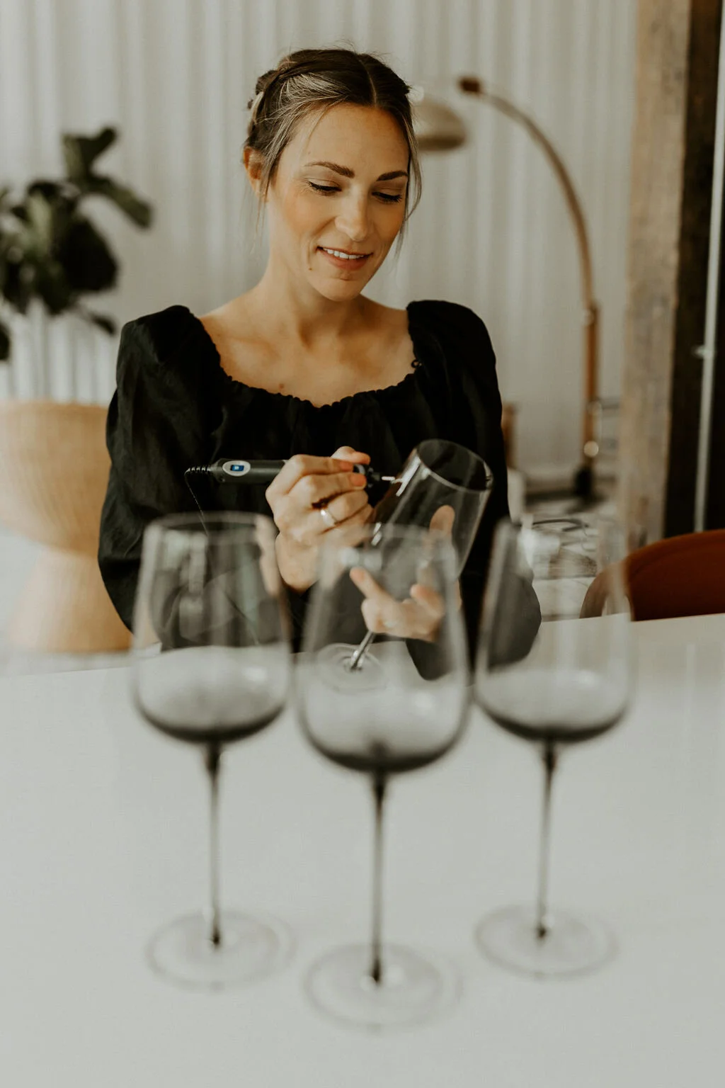Emily Howell calligrapher engraving personalized calligraphy on wine glasses at corporate event