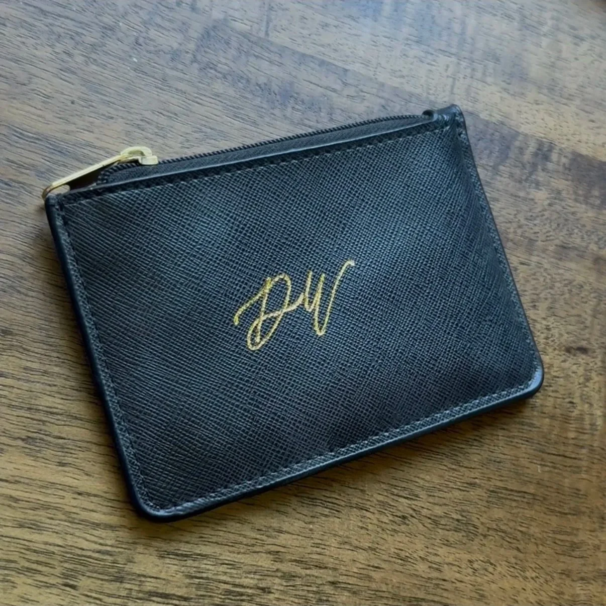 Initials in gold foil calligraphy