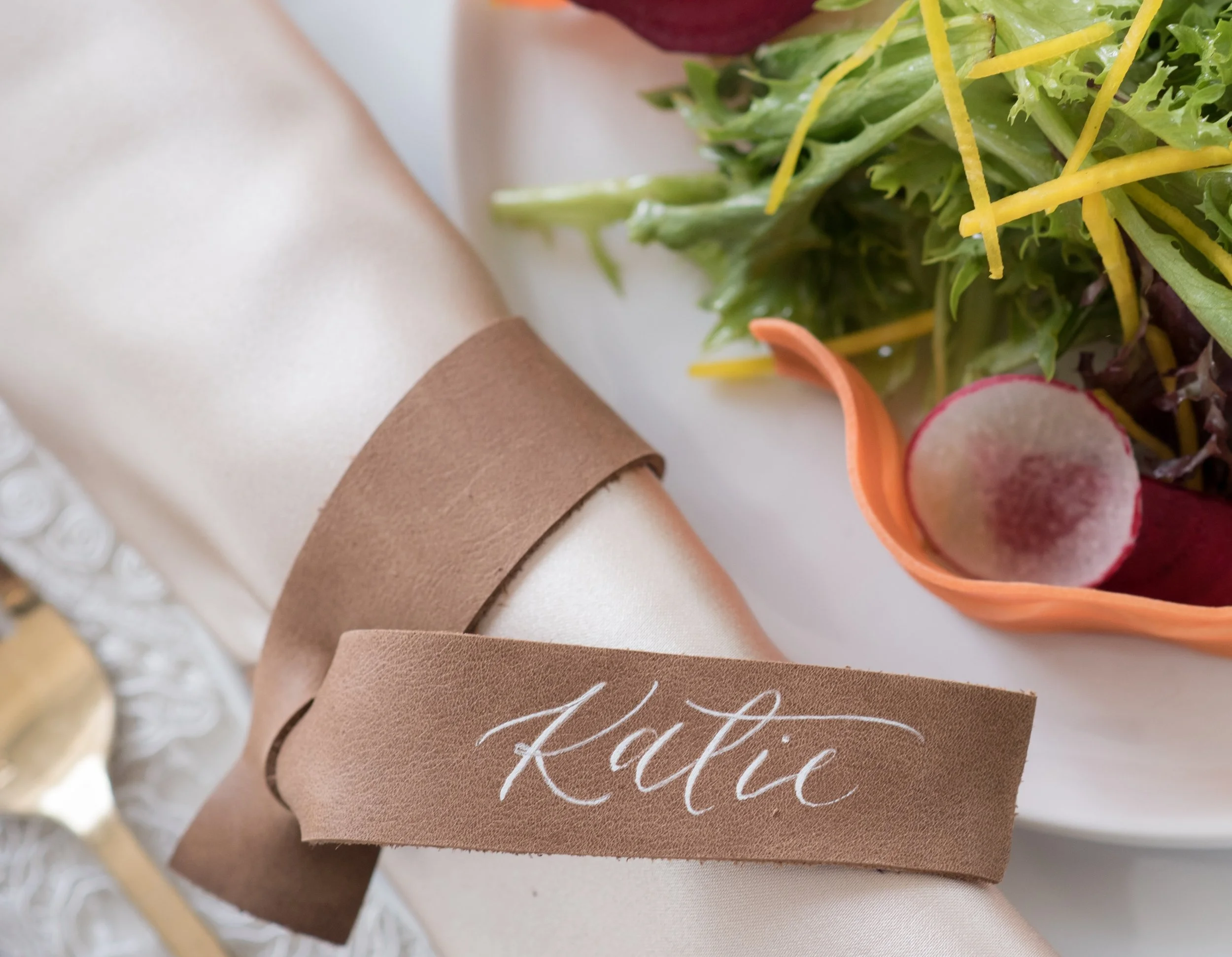 Modern calligraphy hand-lettered place cards with wedding table setting