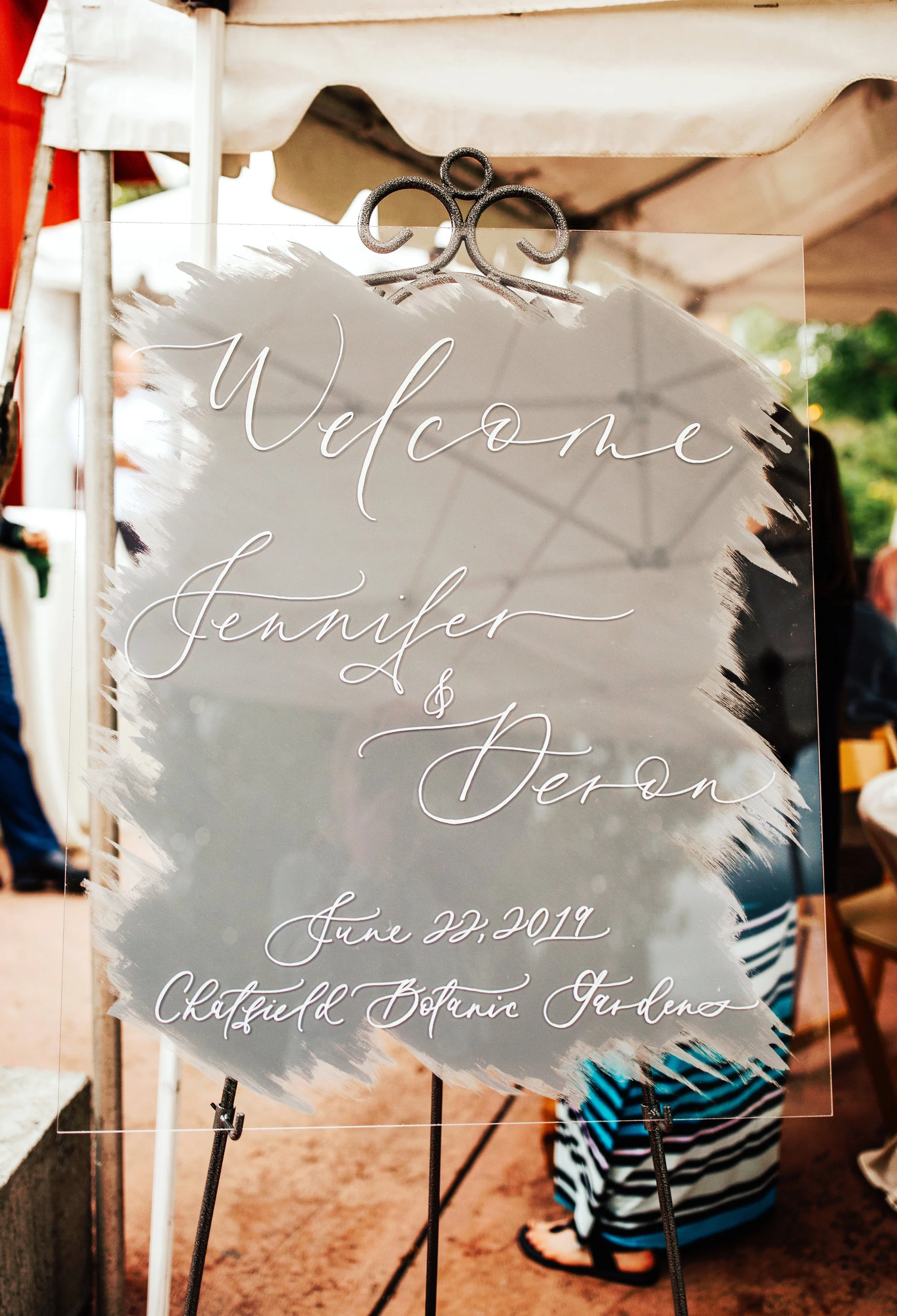 Modern calligraphy hand-lettered acrylic welcome sign on easel for wedding venue