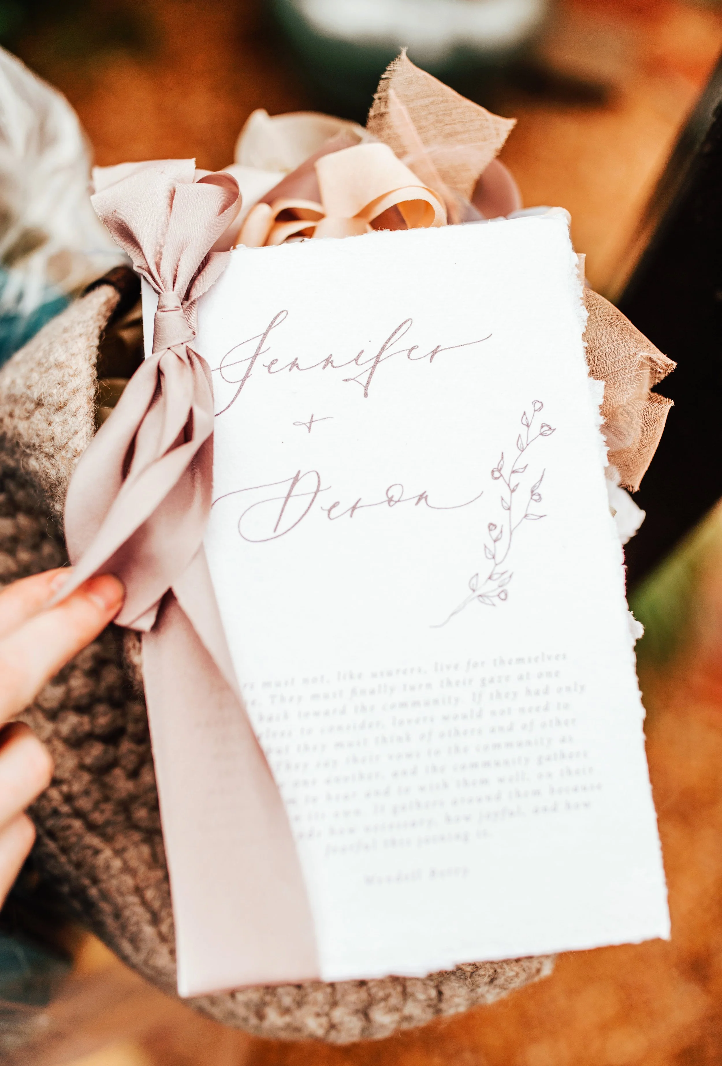 Custom calligraphy hand-lettered wedding program with ribbon ceremony styling