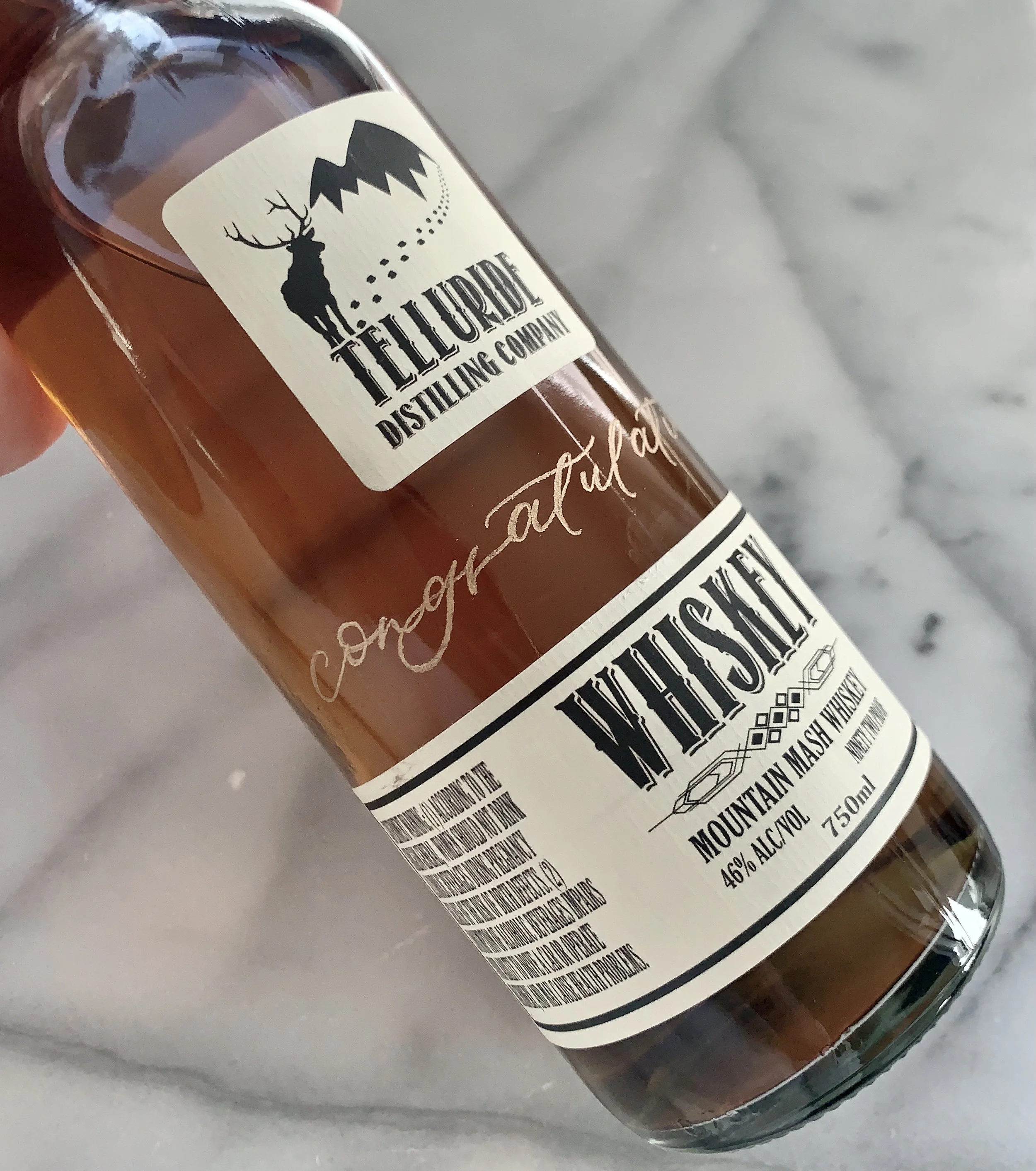 Hand-lettered personalized engraved liquor bottle for corporate event or branded gift