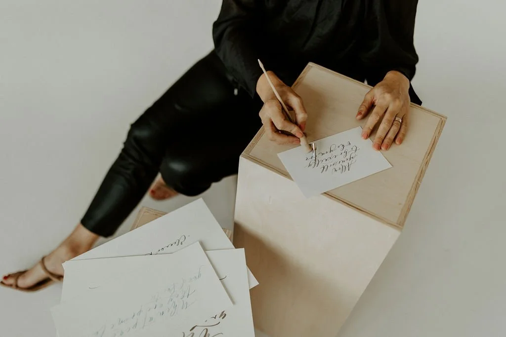 calligraphy artist using a pen to create custom calligraphy