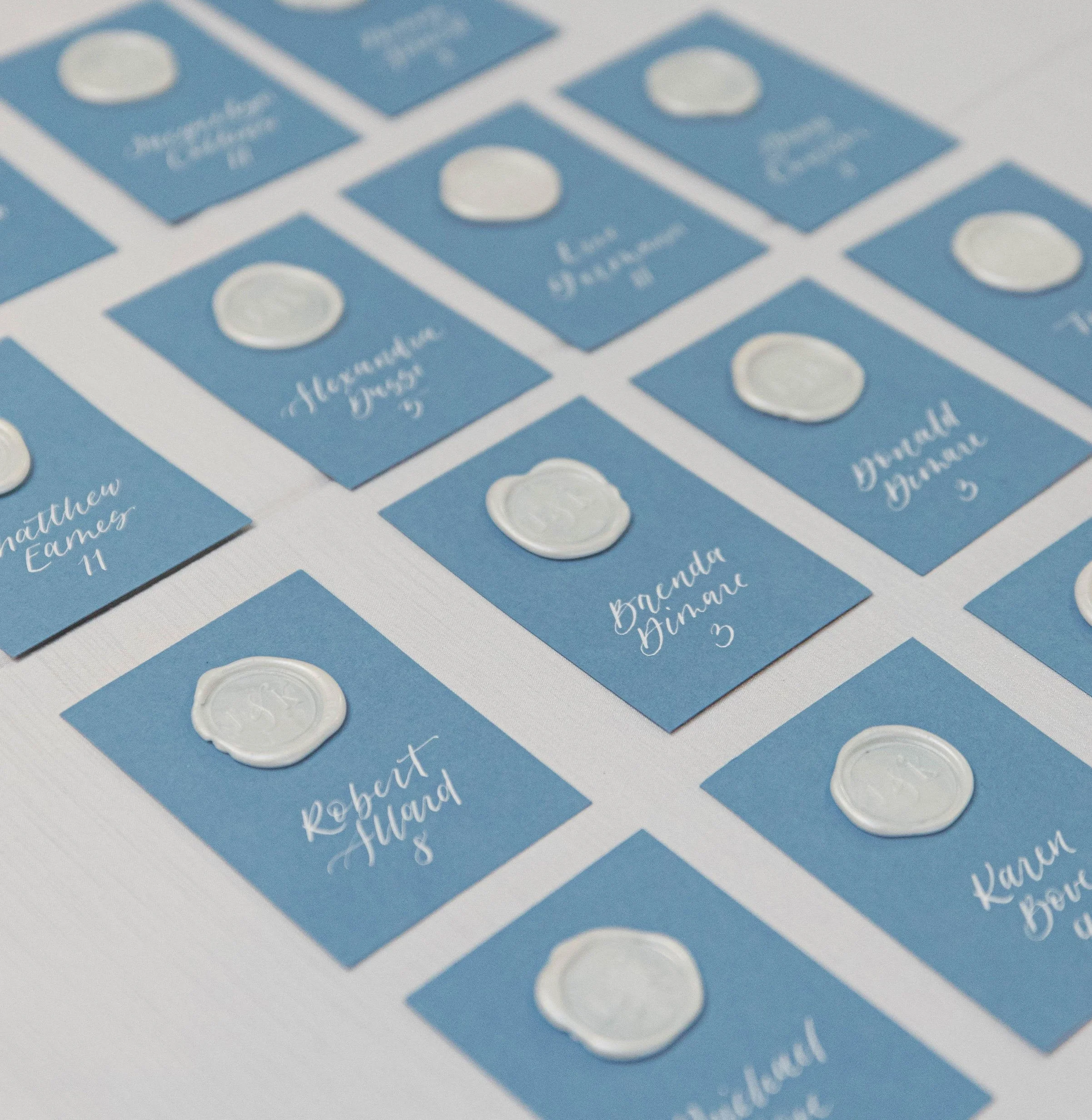 Hand-lettered calligraphy escort cards for elegant wedding reception