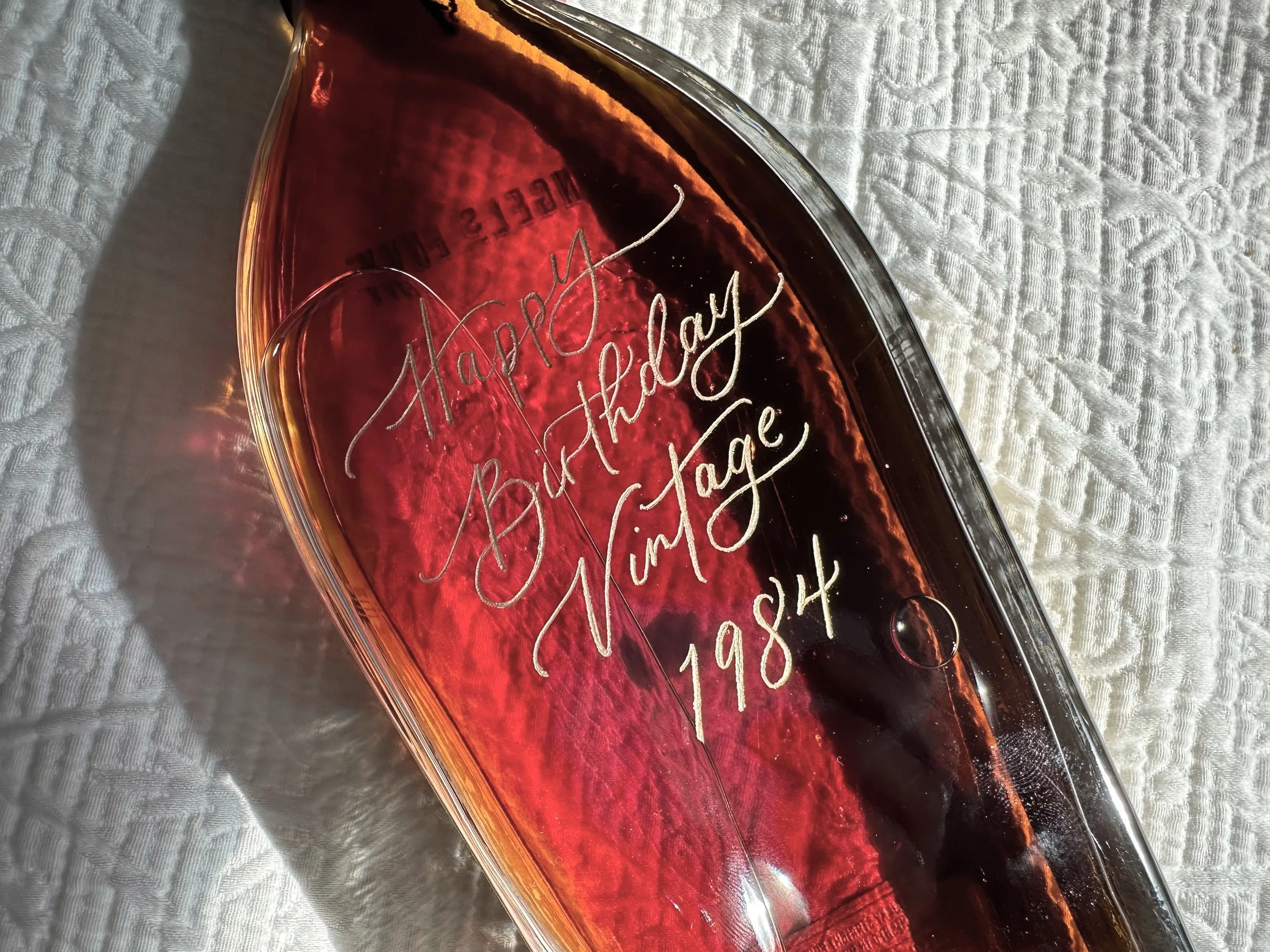 Engraved whiskey bottle with custom calligraphy message