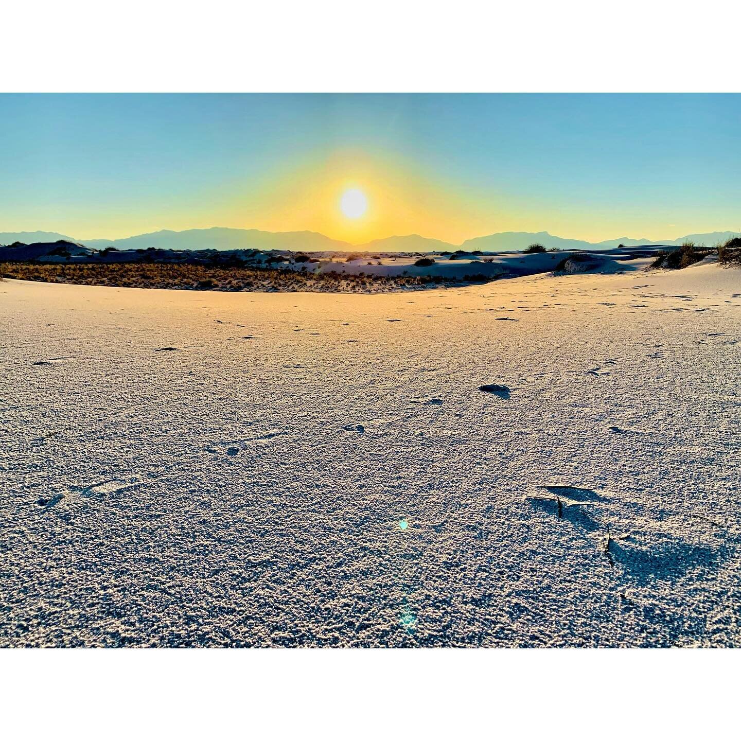 The fleeting spectacle of a White Sands sunset. Every second the light transforms. Fiery oranges lead to soft pinks, while long shadows stretch across the endless white. The purity of the dunes symbolize new beginnings and a connection to the spirit 