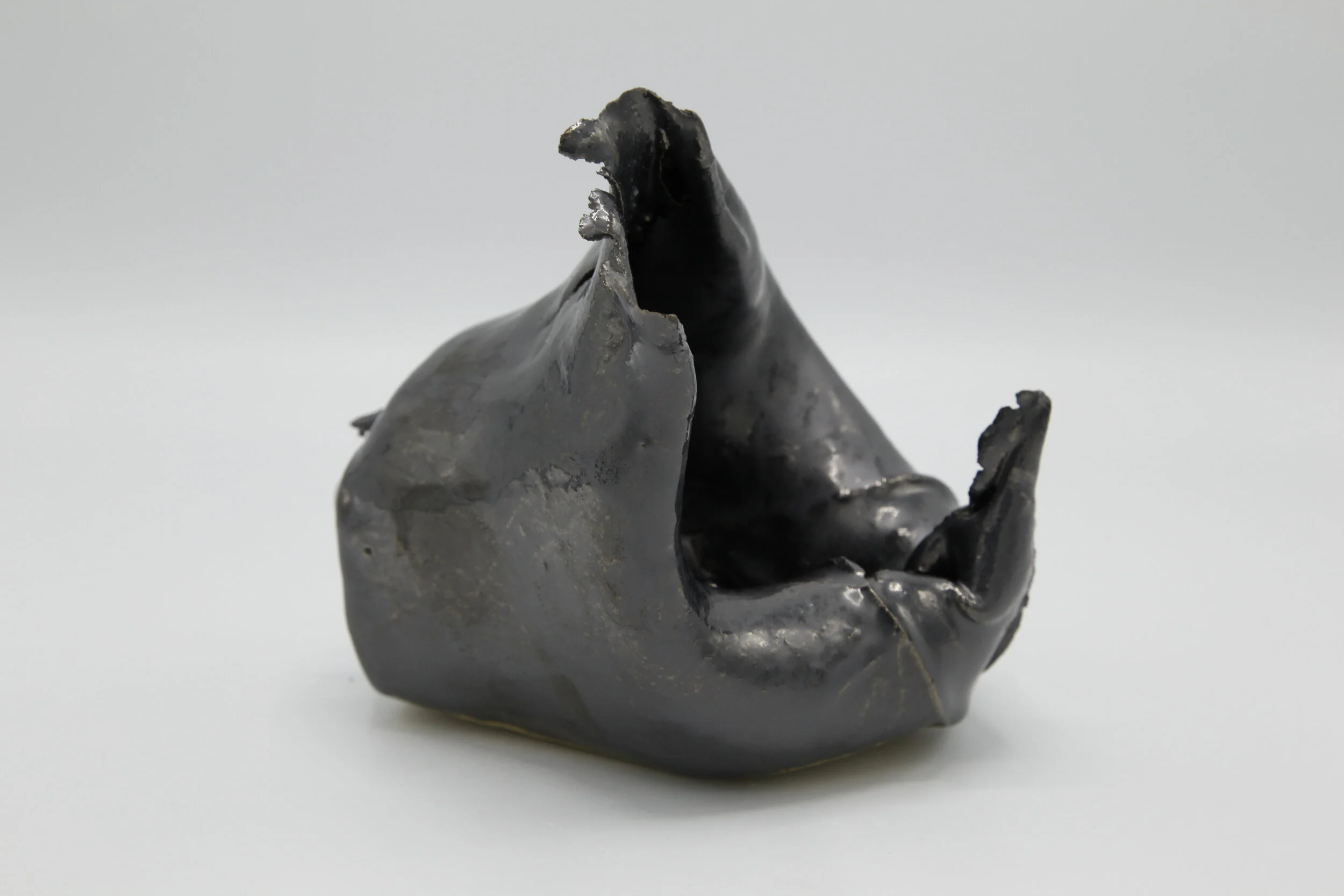   Phoenix Lindsey-Hall    Scream Inside Your Heart #3  2021   Bullet-pierced ceramic with gun metal metallic glaze   6 x 5 x 5 ¼ in 