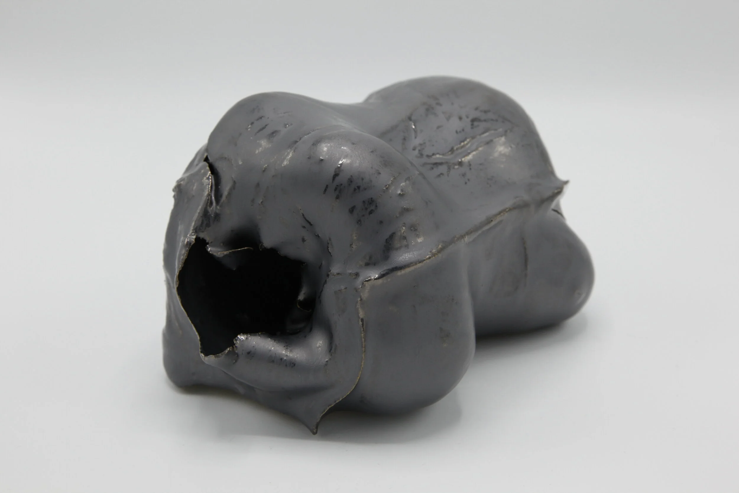   Phoenix Lindsey-Hall    Scream Inside Your Heart #4  2021   Bullet-pierced ceramic with gun metal metallic glaze   8 x 5 x 4 in 