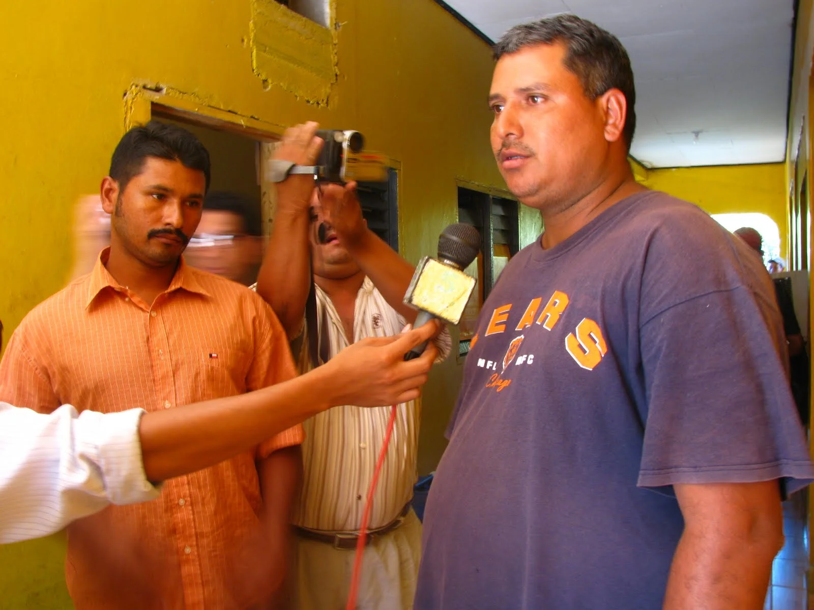 Left to right: two detained campesinos, Osman Alexis Ulloa Flores & Mario Rene Ayala being interviewed by the local press at the police station in Tocoa, Colón, Honduras .