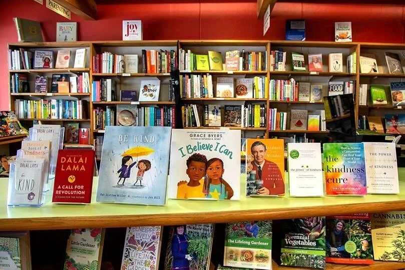 A photograph of the interior of Laughing Oyster Book Shop showing kids books standing up on a shelf with more bookshelves in the backgroud.