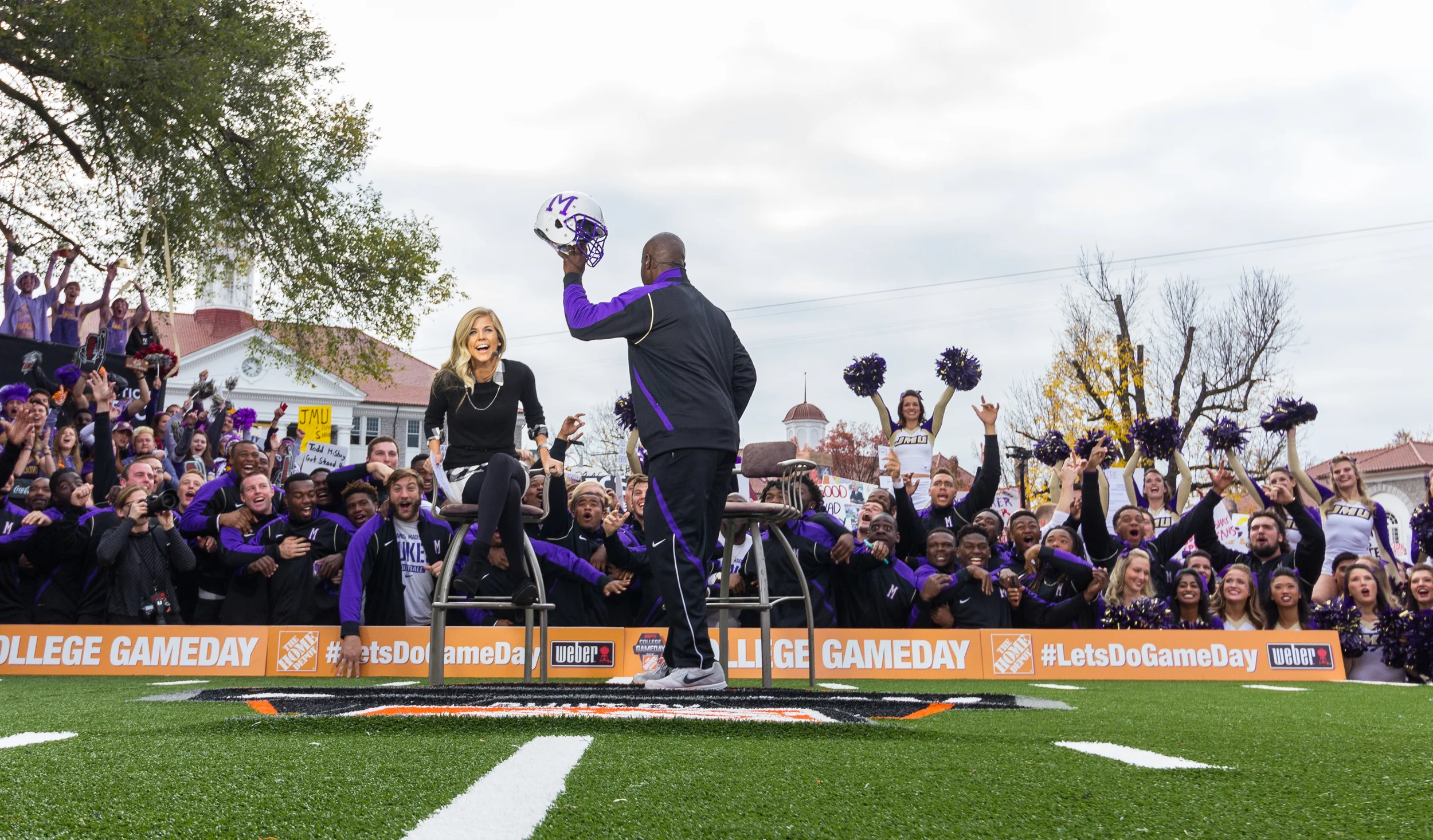 Coach Everett Withers -Head Coach, JMU Football- unveils JMU's new helmet to the his team during an interview with Sam Ponder. 