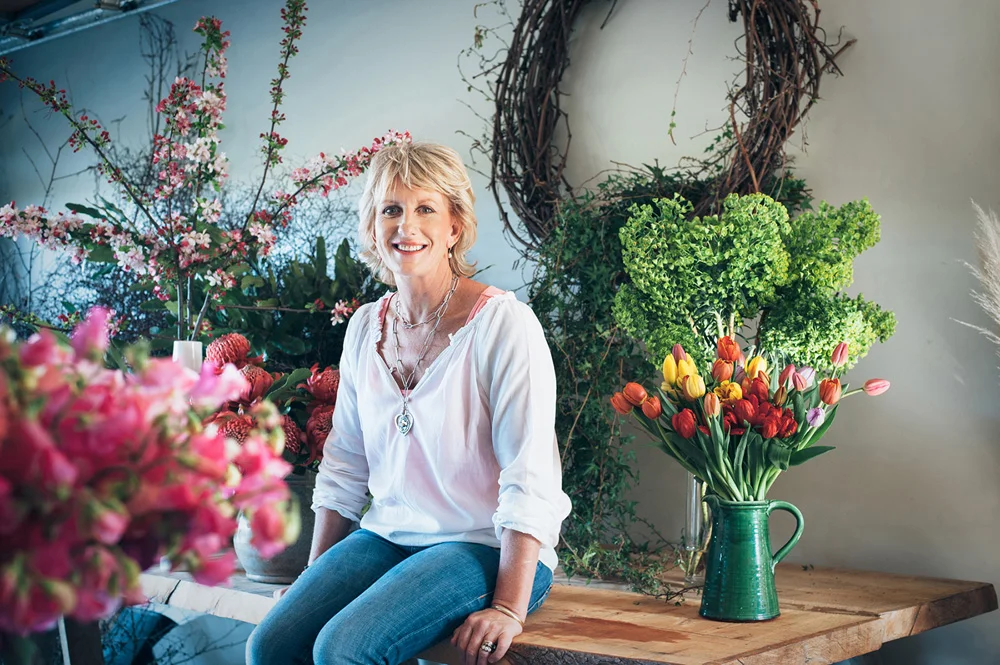 florist sitting among flowerrs.jpg
