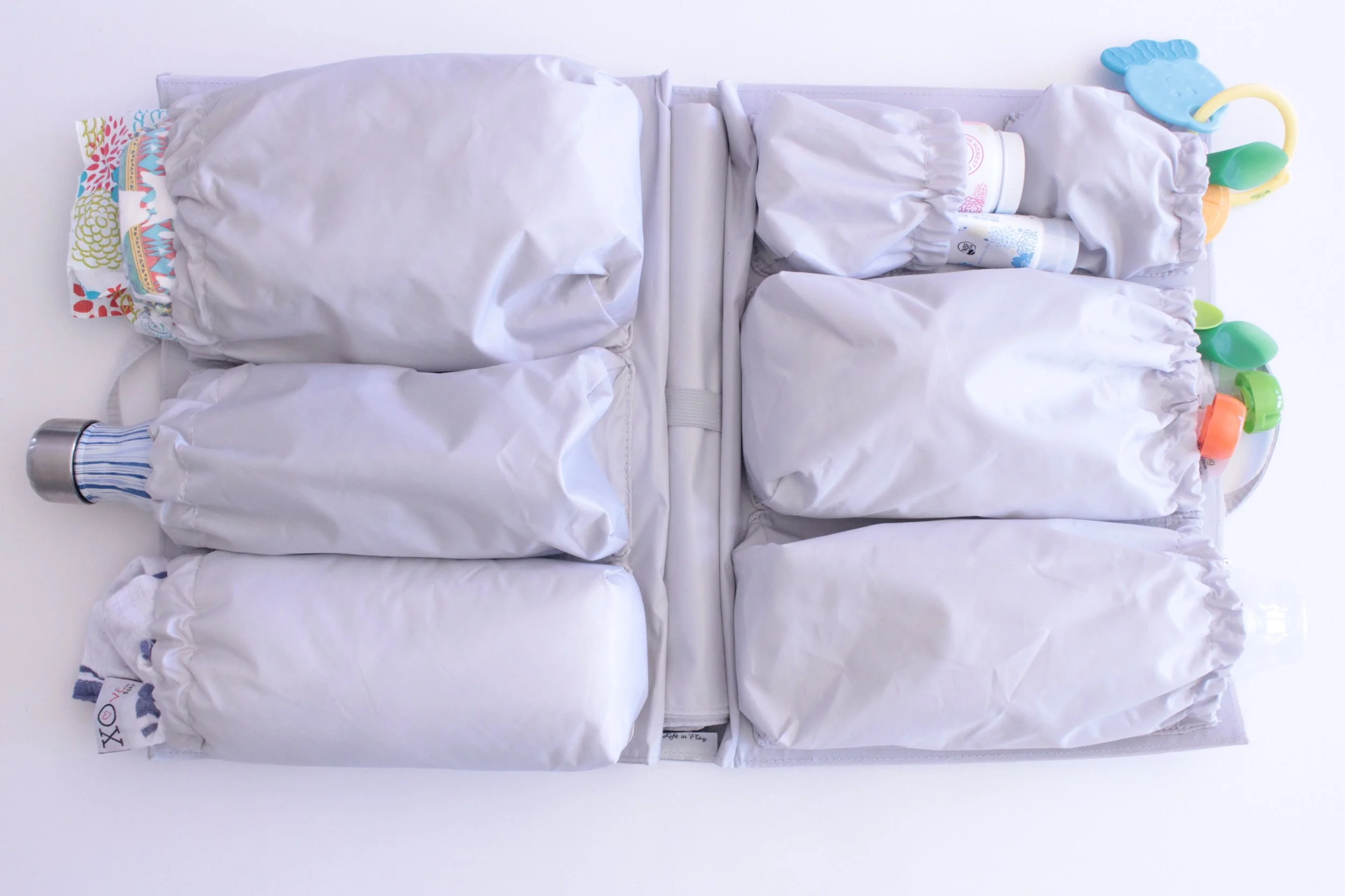 Pockets for everything from diaper changing gear, toys, snacks, and swaddles. 