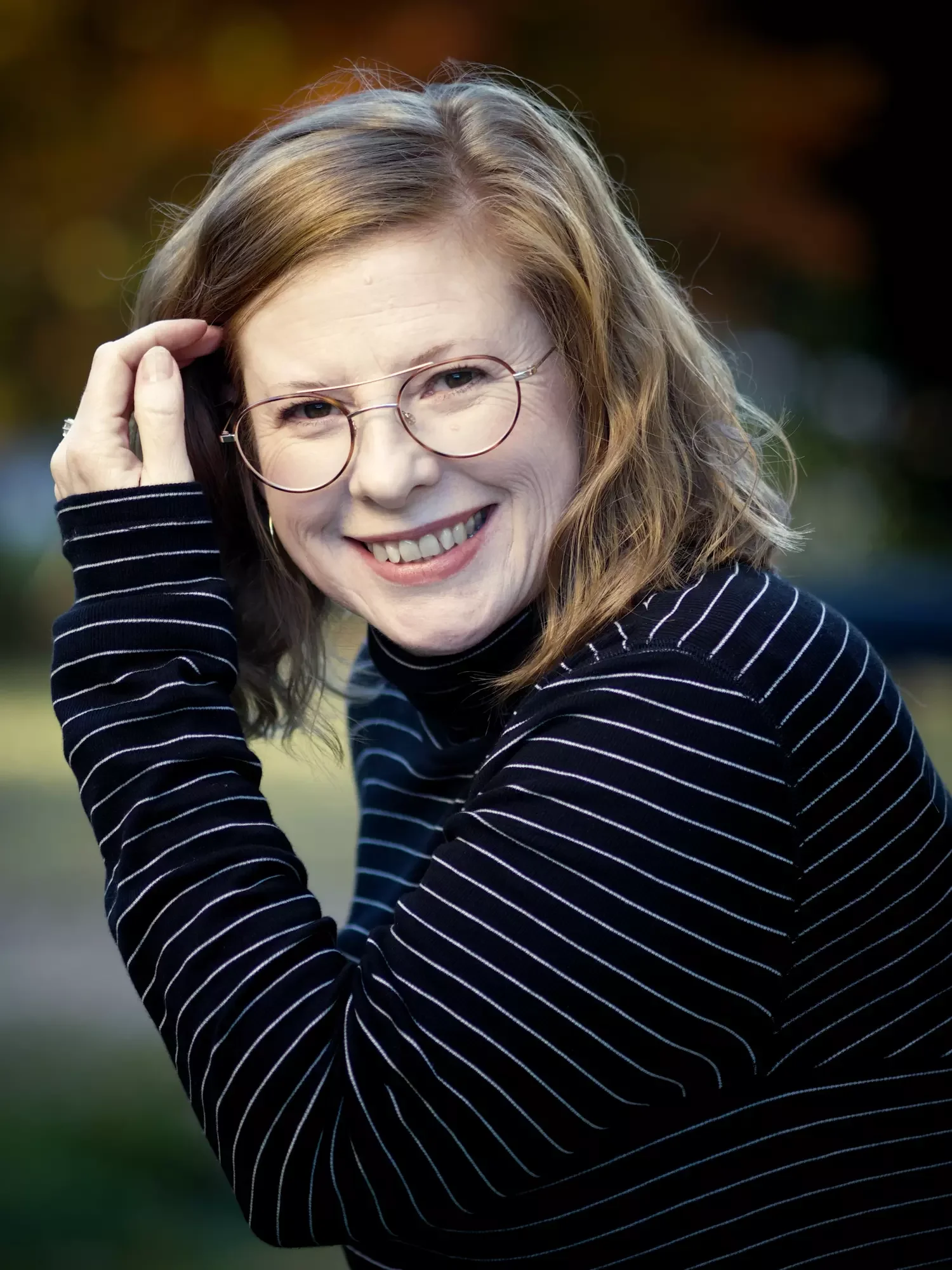 Kayce Hodos, a maternal mental health therapist, smiling in a professional headshot.